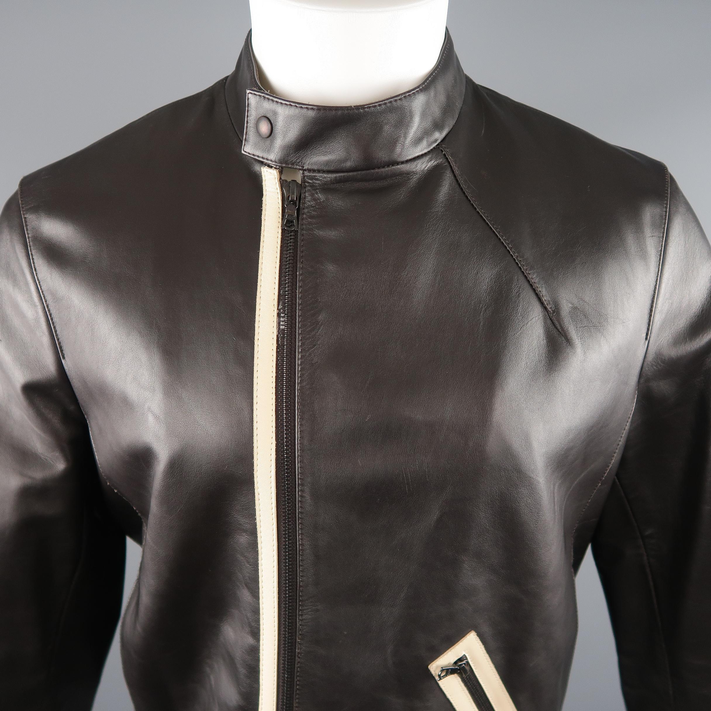 NEIL BARRET Motorcycle Jacket comes in a brown tone in a solid leather material, with a cream trim, zip pocket, zip up and snaps. Minor wear throughout. Made in Italy. Retail price $ 2,195.00. 
 
Very Good Pre-Owned Condition.
Marked: M
