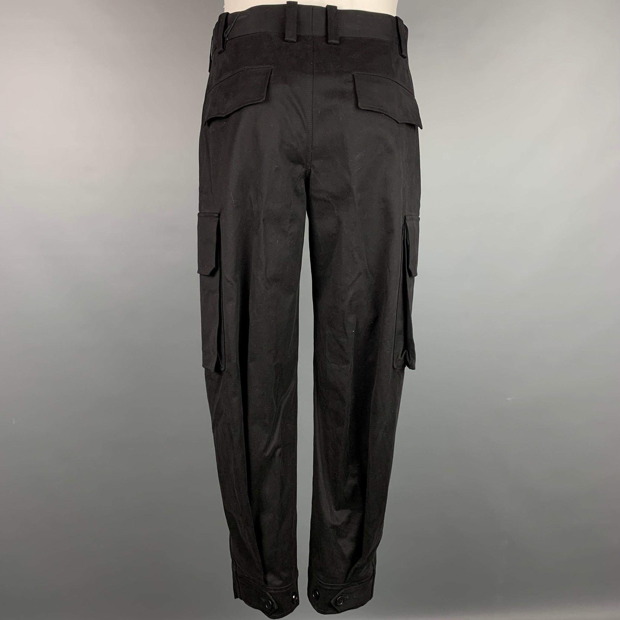 NEIL BARRETT casual pants comes in a black cotton featuring a cargo style, patch pockets, and a zip fly closure. Made in Italy. 

New With Tags. 
Marked: 46
Original Retail Price: $647.00

Measurements:

Waist: 32 in.
Rise: 12 in.
Inseam: 28 in. 