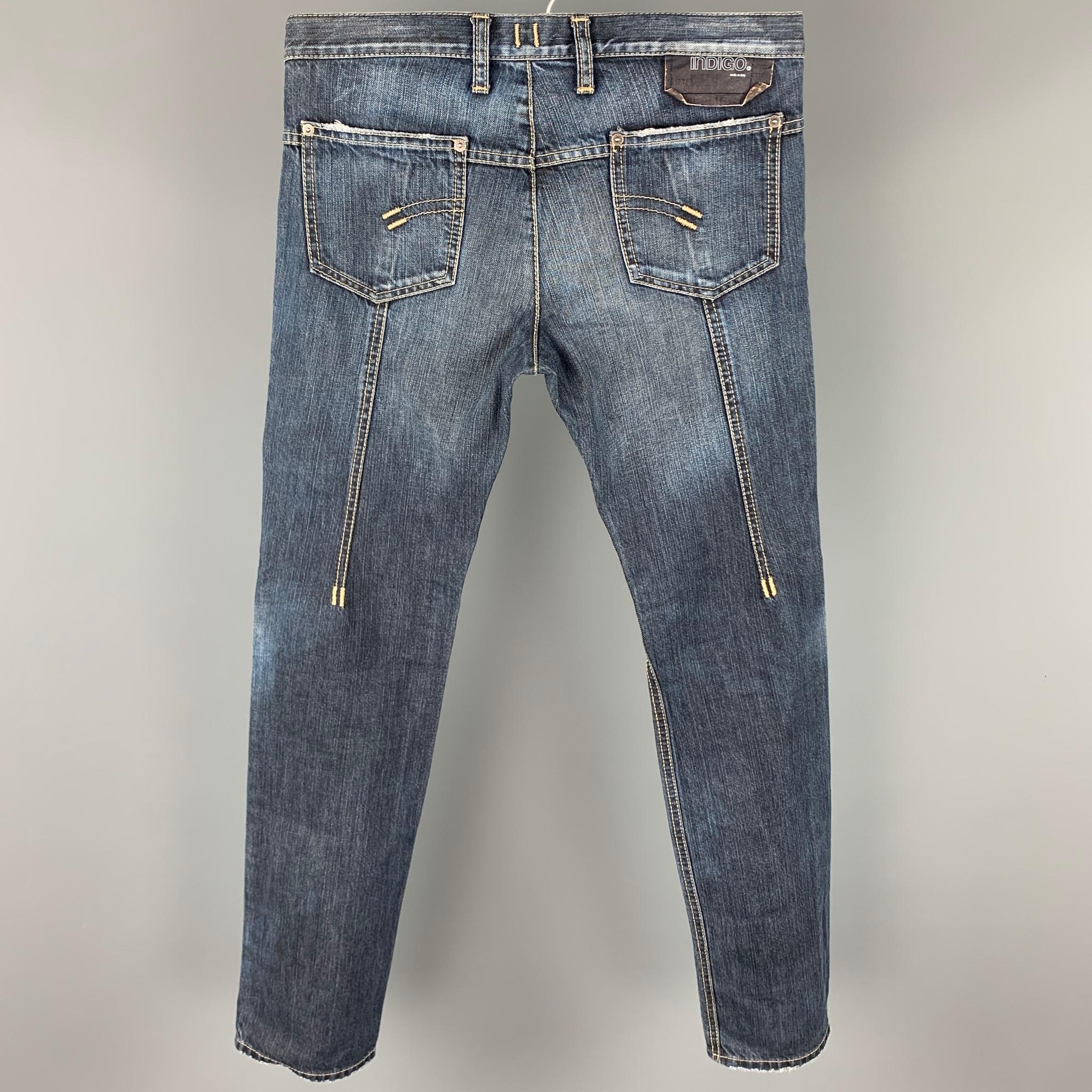 NEIL BARRETT jeans comes in a indigo denim with contrast stitching featuring a slim fit, zipper pocket, and a button fly closure. Made in Italy.

Very Good Pre-Owned Condition.
Marked: 30

Measurements:

Waist: 32 in.
Rise: 9.5 in.
Inseam: 33 in. 