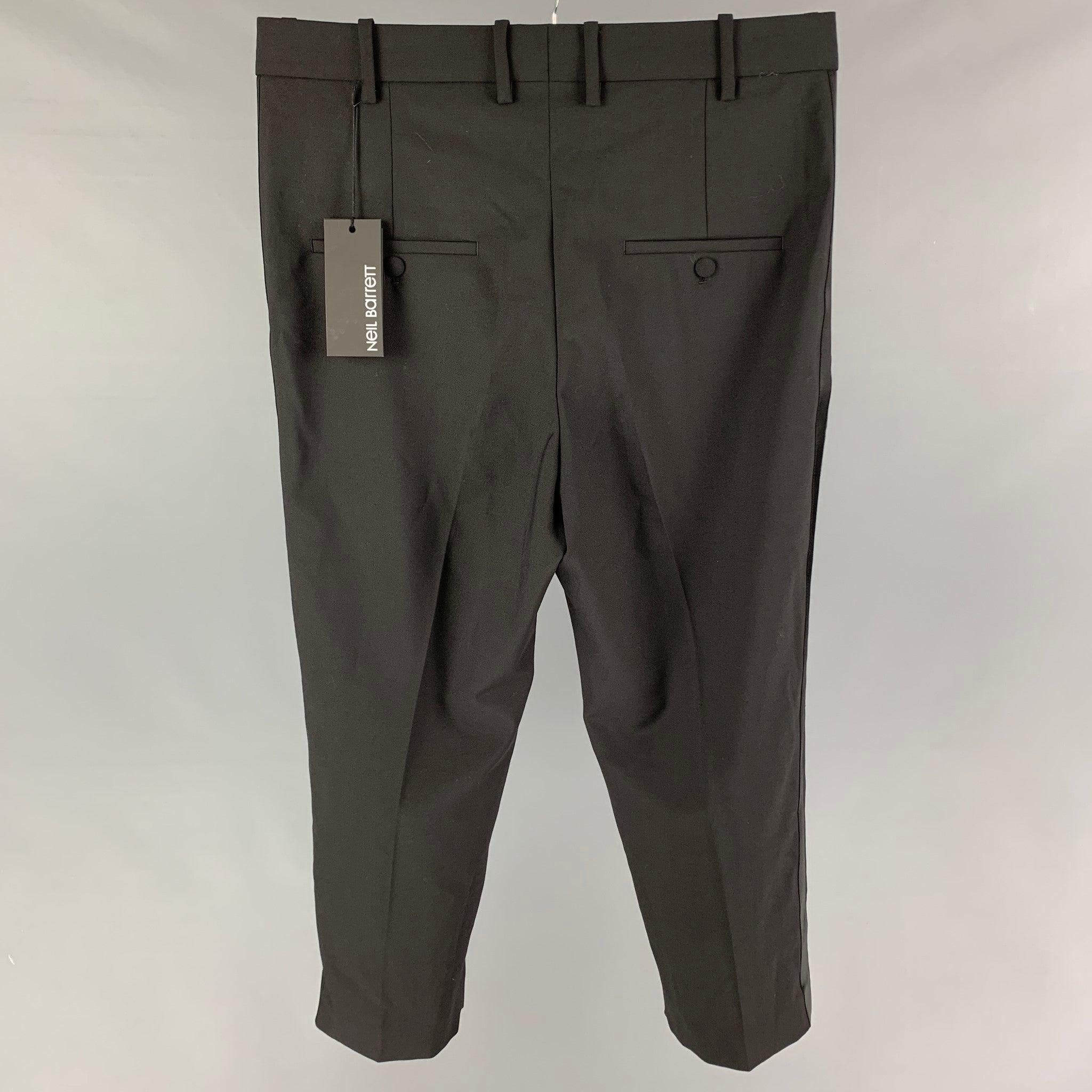 NEIL BARRETT dress pants comes in a black polyester blend featuring a cropped leg, tuxedo stripe, front tab, and a zip fly closure. Made in Italy.
New With Tags.  

Marked:   48 

Measurements: 
  Waist: 34 inches  Rise: 15 inches  Inseam: 24 inches