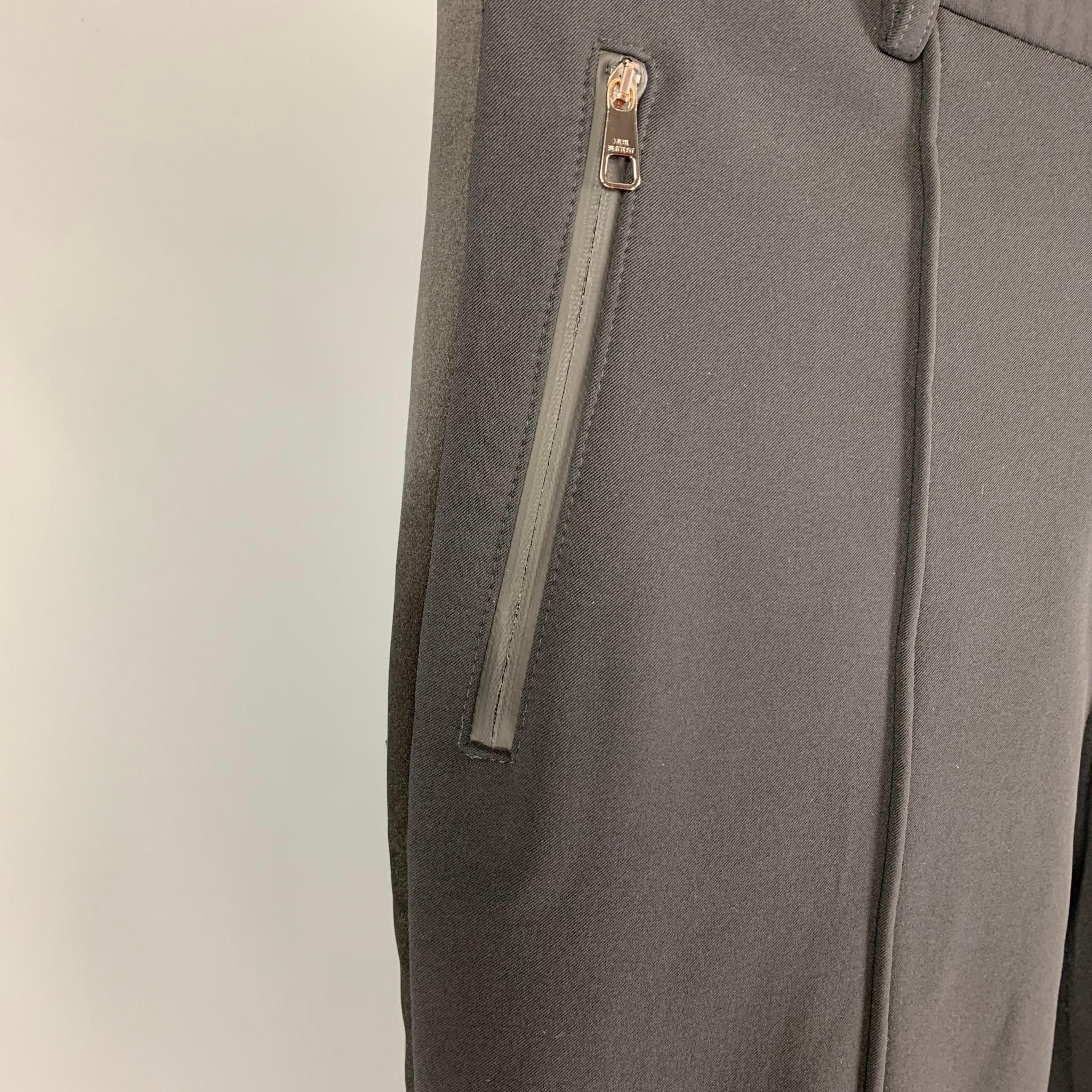 NEIL BARRETT dress pants comes in a black material featuring a skinny fit, tuxedo stripe, pleated, zipper pockets, silver tone hardware, front tab, and a zip fly closure. Made in Italy. 

Very Good Pre-Owned Condition. Fabric tag not
