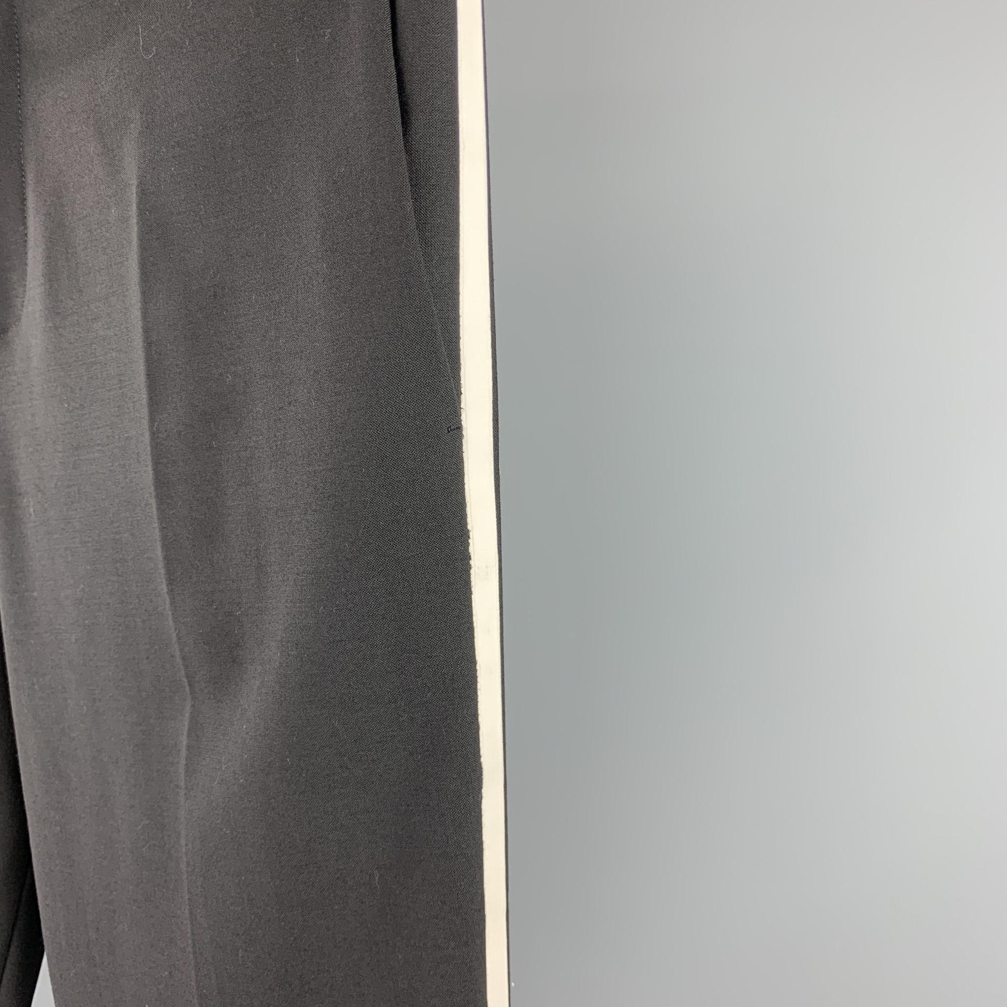NEIL BARRETT dress pants comes in a black polyester with a white tuxedo stripe featuring a slim fit, regular rise, and a zip fly closure. As-Is. Made in Italy.

Very Good Pre-Owned Condition.
Marked: IT 52

Measurements:

Waist: 38 in. 
Rise: 11 in.