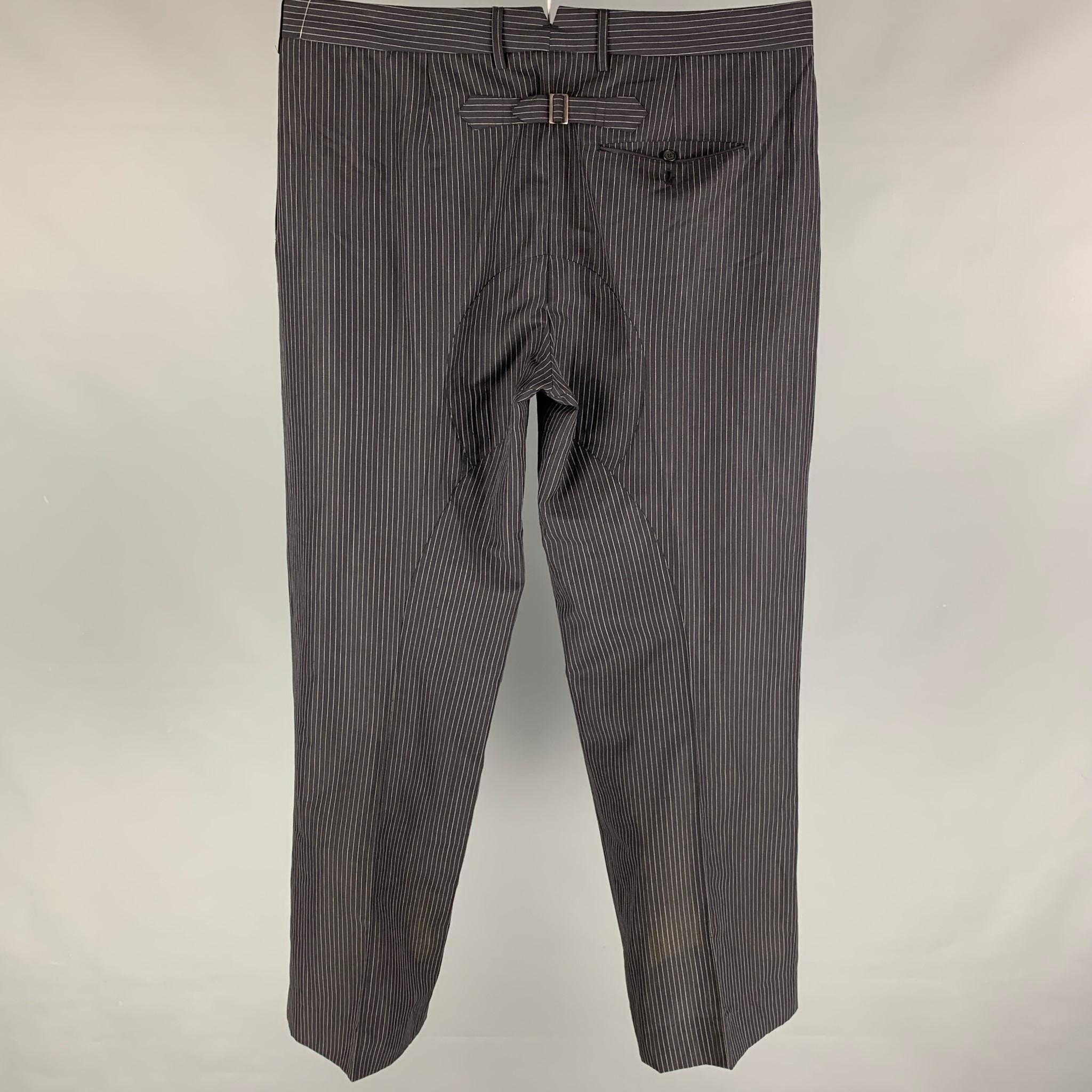 NEIL BARRETT dress pants comes in a black stripe wool featuring a pleated style, wide leg, and a zip fly closure. Made in Italy. 

Very Good Pre-Owned Condition.
Marked: 52

Measurements:

Waist: 38 in.
Rise: 10.5 in.
Inseam: 32.5 in. 