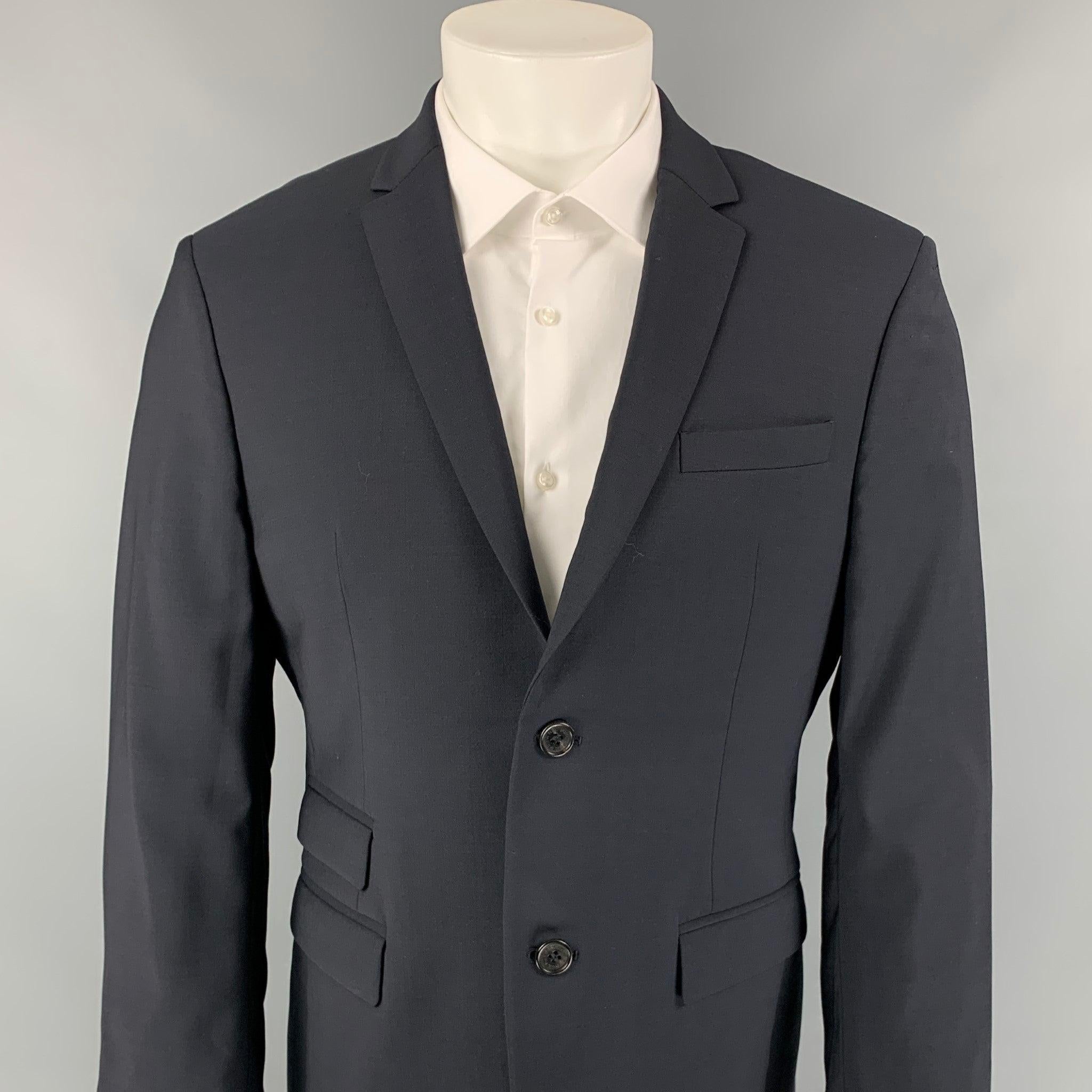 NEIL BARRETT sport coat comes in a navy wool with a full liner featuring a slim fit, notch lapel, double back vent, flap pockets, and a double button closure. Made in Italy.
Very Good Pre-Owned Condition. 

Marked:   50 

Measurements: 
 
Shoulder: