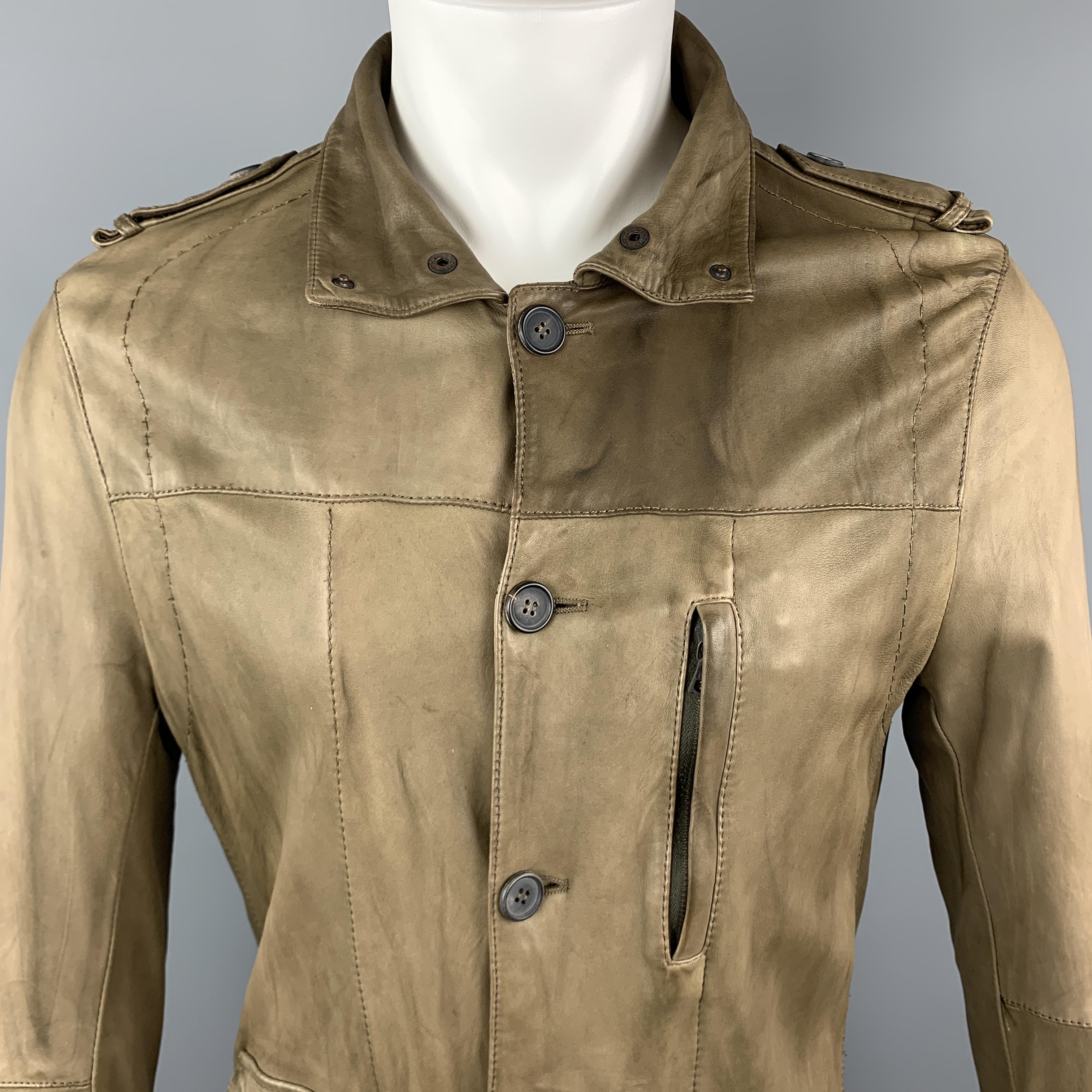 NEIL BARET jacket comes in light weight taupe leather with a folded snap collar, button up front, flap and zip pockets, epaulets, and top stitching. Wear throughout. Made in Italy.

Good Pre-Owned Condition.
Marked:

Measurements:

Shoulder: 17