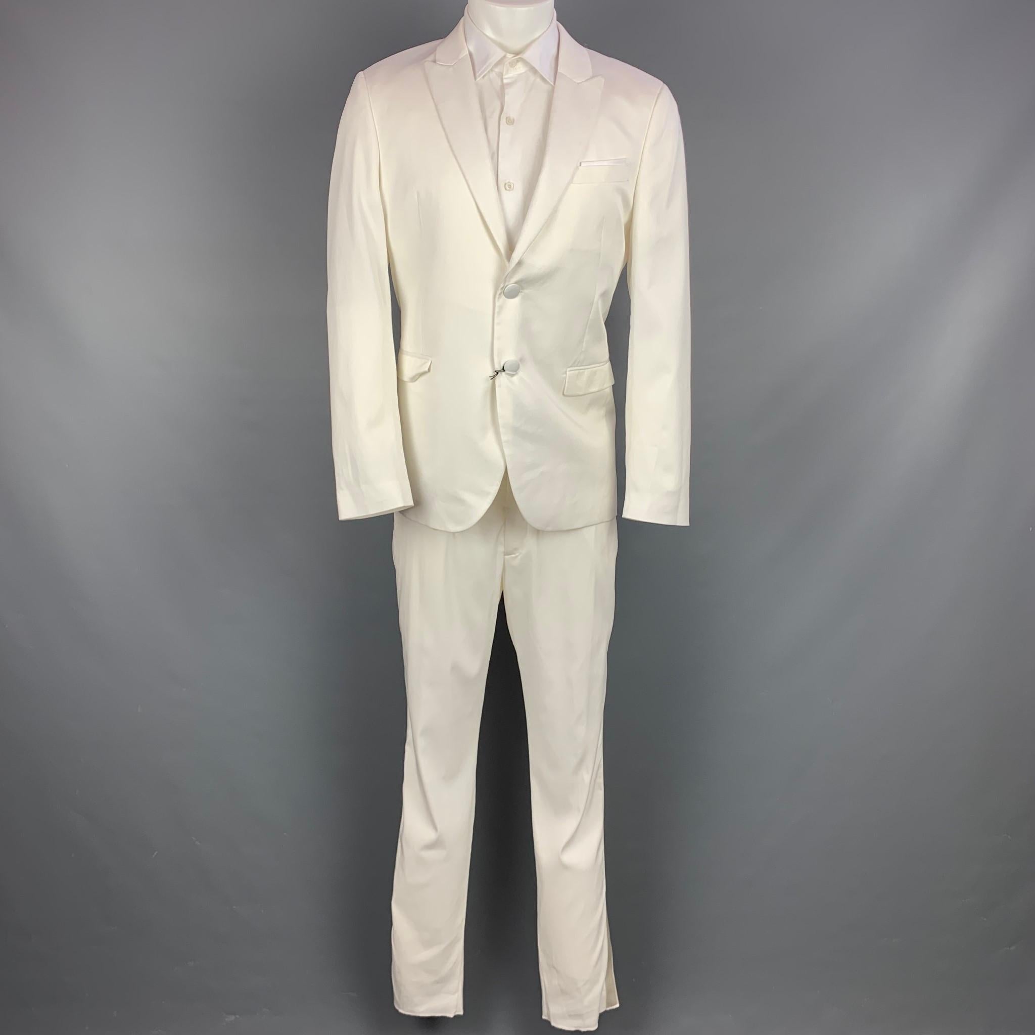 NEIL BARRETT suit comes in a white tencel with a full liner and includes a single breasted, double button sport coat with lapel peak and matching flat front trousers. Made in Italy.

New With Tags.
Marked: Jacket: IT 50
Pants: IT 50
Original Retail