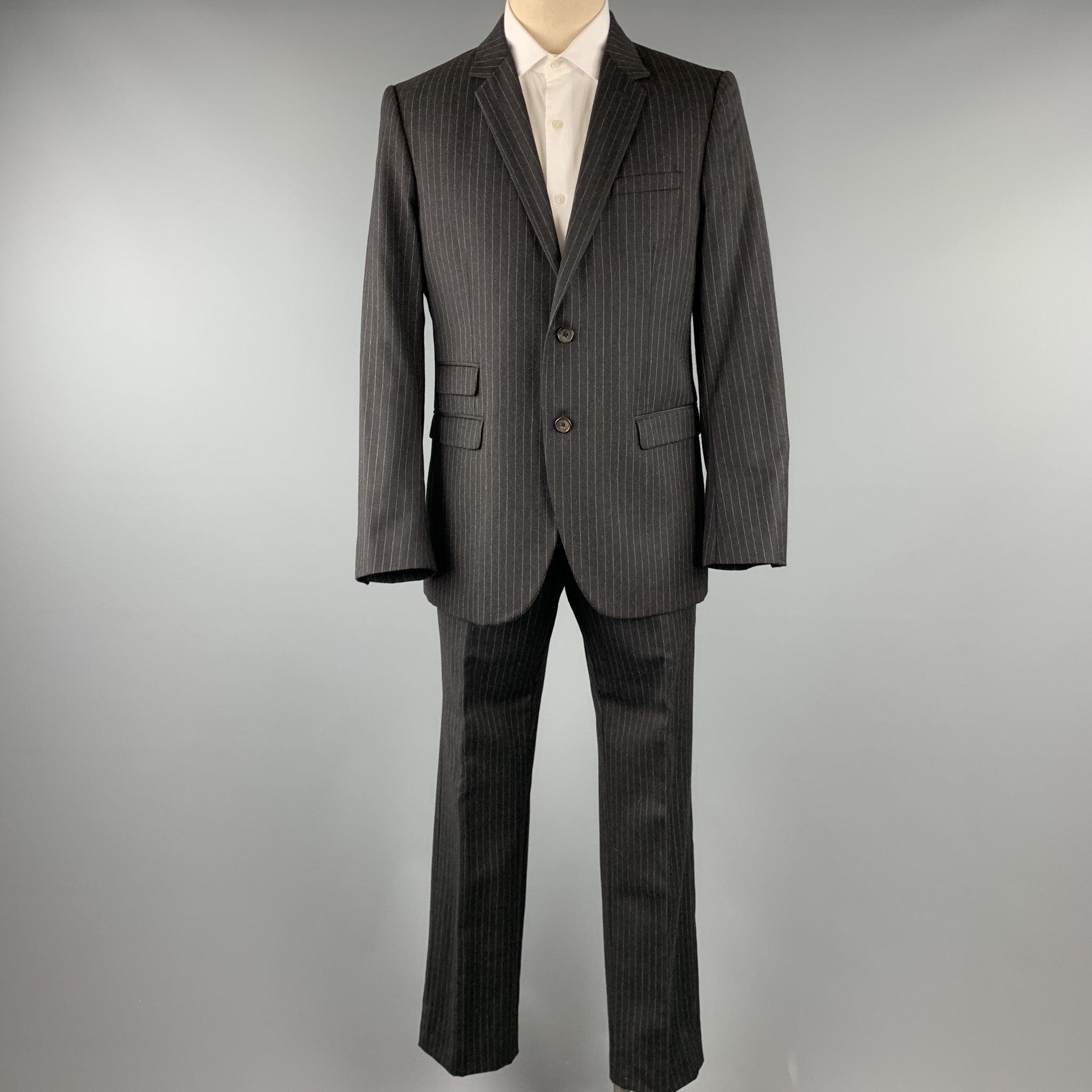 NEIL BARRETT
suit comes in a charcoal stripe wool and includes a single breasted, two button sport coat with a notch lapel and matching flat front trousers.
Excellent Pre-Owned Condition. 

Marked:   L 

Measurements: 
  -JacketShoulder: 17.5 inches