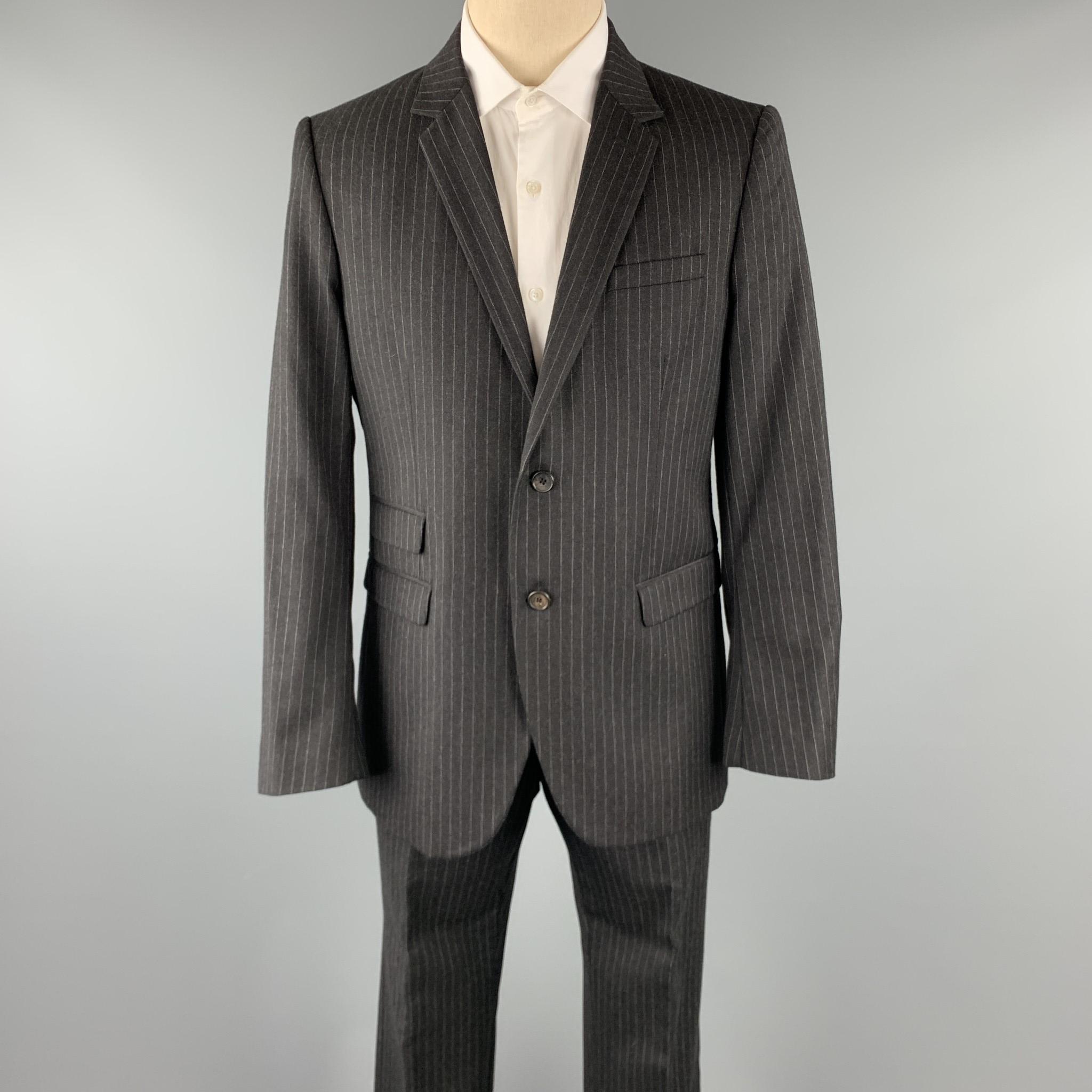 NEIL BARRETT suit comes in a charcoal stripe wool and includes a single breasted, two button sport coat with a notch lapel and matching flat front trousers. 

Excellent Pre-Owned Condition.
Marked: L

Measurements:

-Jacket
Shoulder: 17.5 in.
