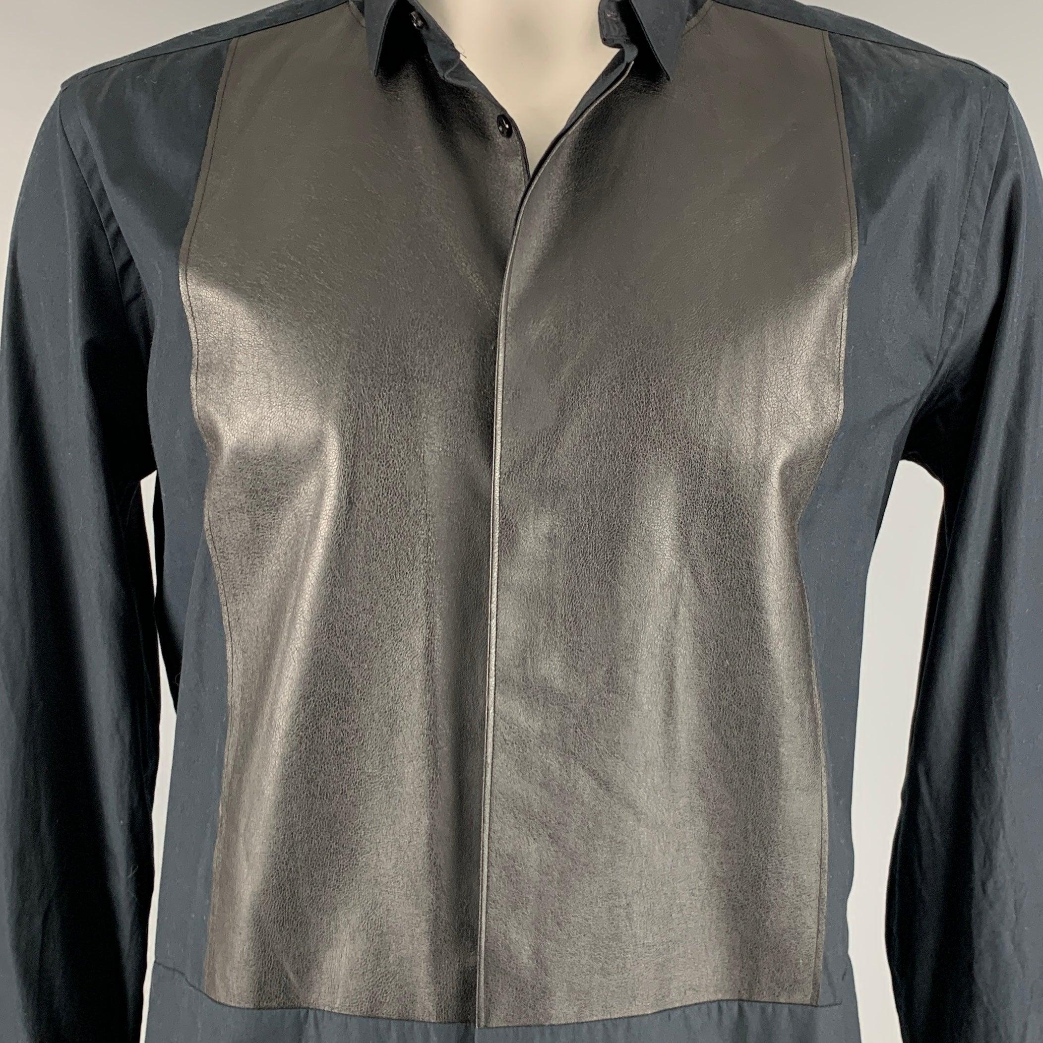 NEIL BARRETT long sleeve shirt
in a black cotton fabric featuring
polyester faux leather front, skinny fit, and hidden button closure. Made in Italy.Excellent Pre-Owned Condition. 

Marked:   43/17 

Measurements: 
 
Shoulder: 18 inches Chest: 44