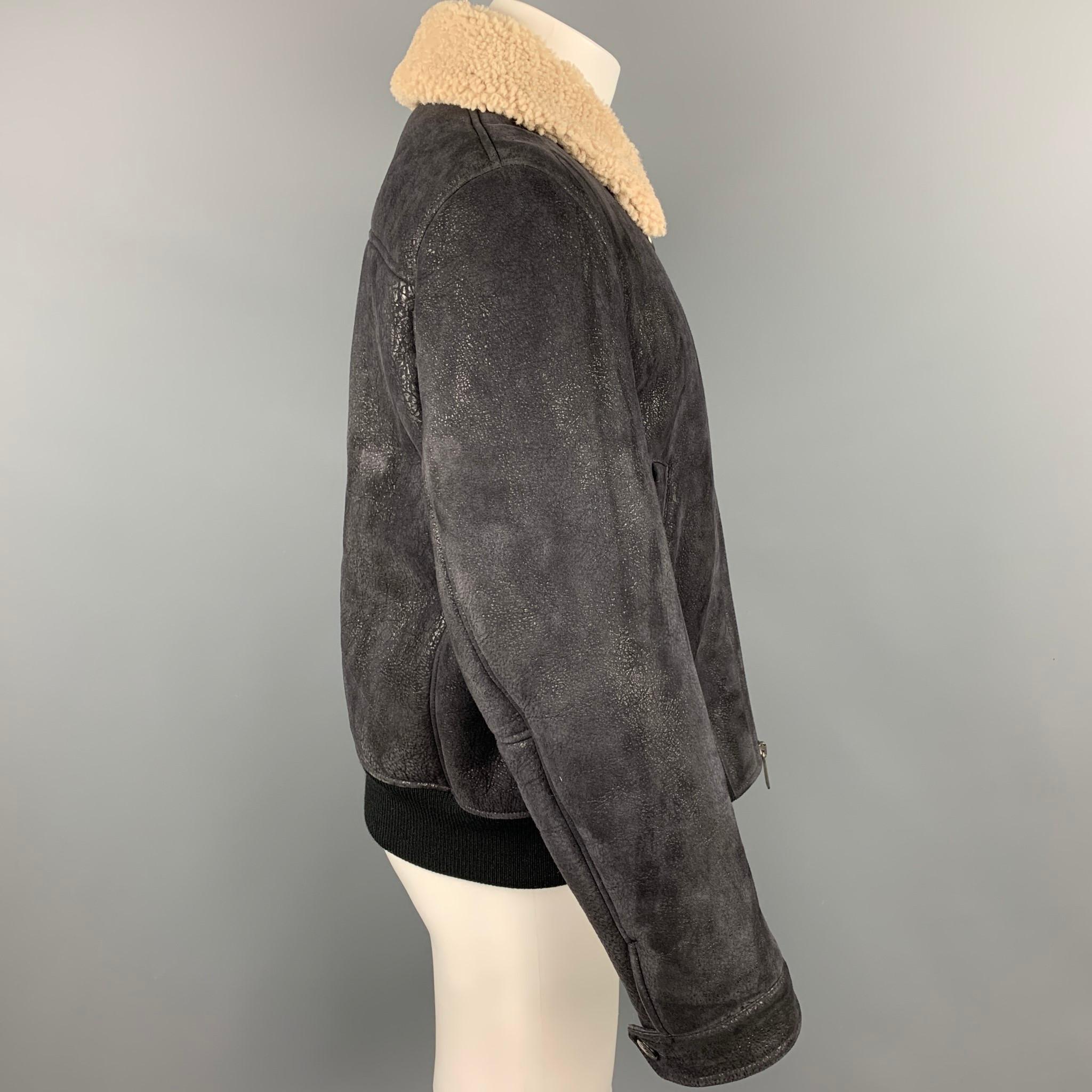 NEIL BARRETT jacket comes in a black textured lambskin featuring a skinny fit, fur collar, ribbed hem, slit pockets, anda full zip up closure. Made in Italy.

Very Good Pre-Owned Condition.
Marked: L

Measurements:

Shoulder: 17.5 in.
Chest: 44