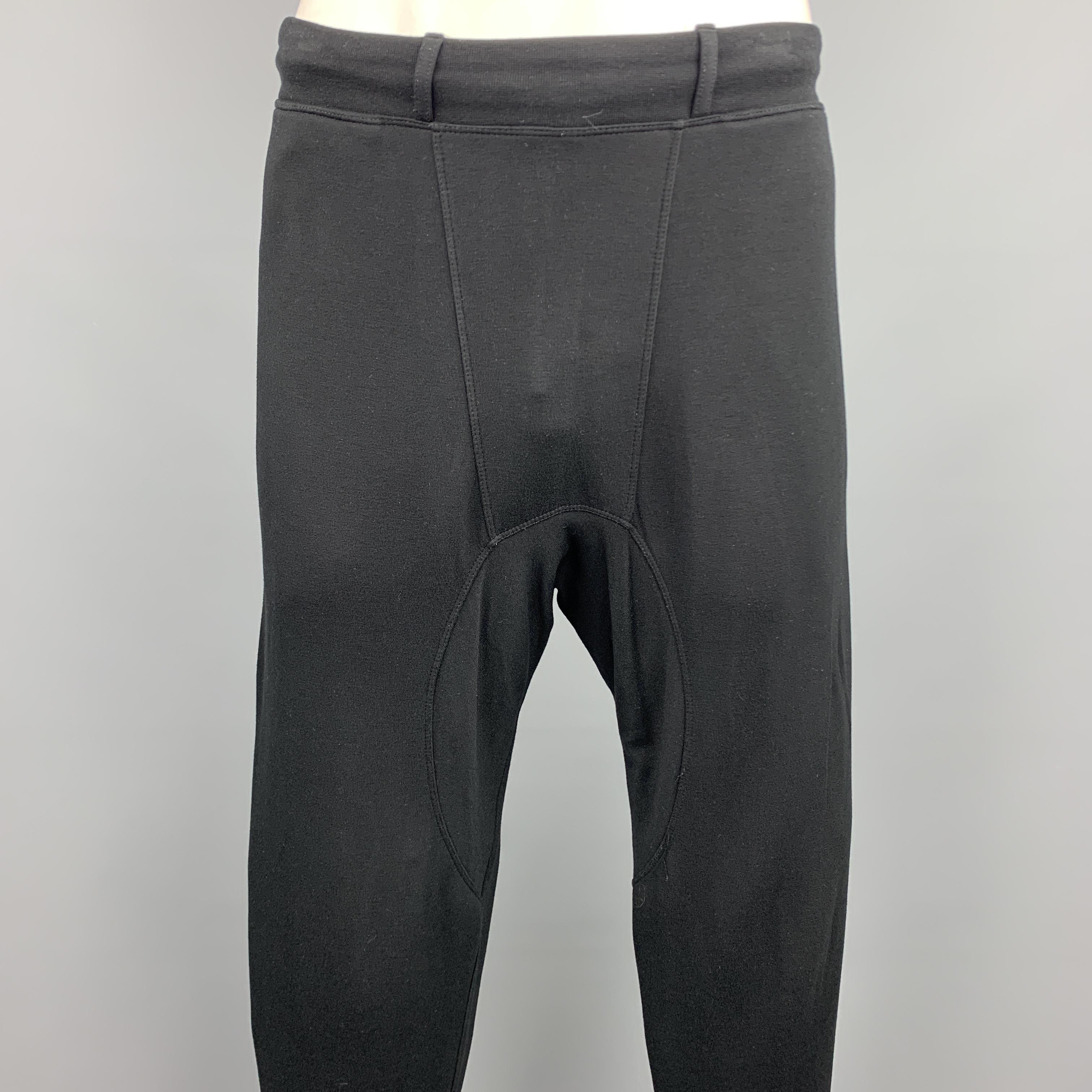 NEIL BARRETT casual pants comes in a black viscose / elastane featuring a drop-crotch style, elastic cuffs, and a drawstring closure. Made in Portugal.

Excellent Pre-Owned Condition.
Marked: L

Measurements:

Waist: 38 in. 
Rise: 9.5 in. 
Inseam: