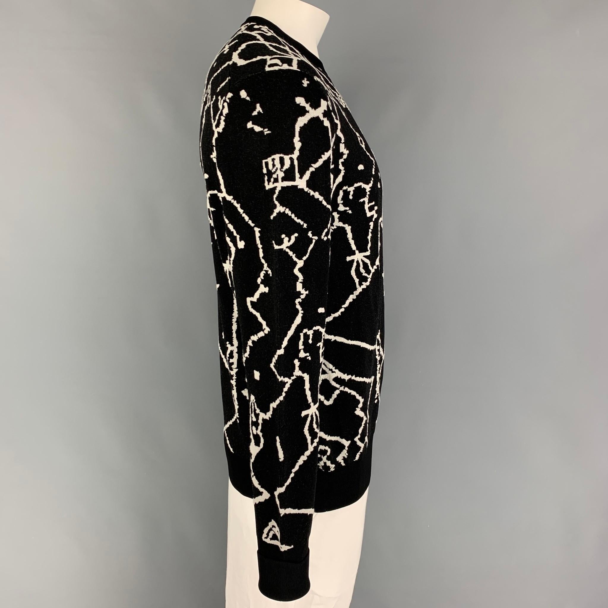 NEIL BARRETT sweater comes in a black & white abstract print wool  / viscose featuring a slim wide fit and crew-neck. 

Very Good Pre-Owned Condition.
Marked: L

Measurements:

Shoulder: 18 in.
Chest: 44 in.
Sleeve: 30.5 in.
Length: 28.5 in. 