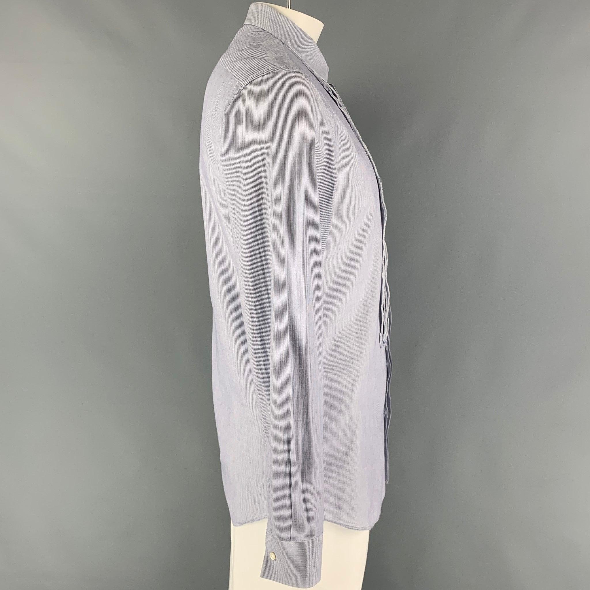 NEIL BARRETT long sleeve shirt comes in a blue stripe cotton featuring a slim fit, raw edge, spread collar, and a hidden placket closure. Made in Italy.
Very Good
Pre-Owned Condition. 

Marked:   16.5/42 

Measurements: 
 
Shoulder: 19 inches 