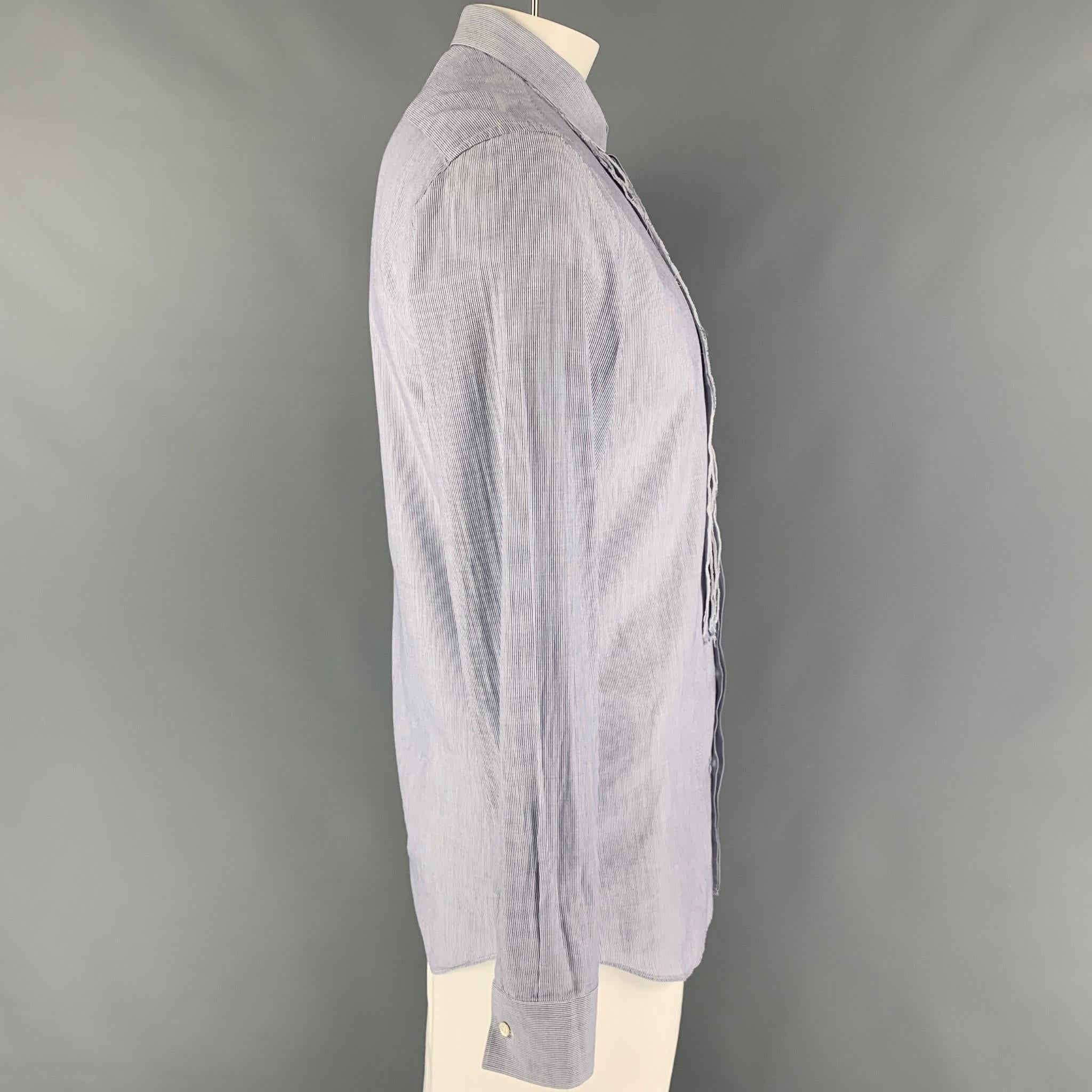 NEIL BARRETT long sleeve shirt comes in a blue stripe cotton featuring a slim fit, raw edge, spread collar, and a hidden placket closure. Made in Italy. 

Very Good Pre-Owned Condition.
Marked: 16.5/42

Measurements:

Shoulder: 19 in.
Chest: 42