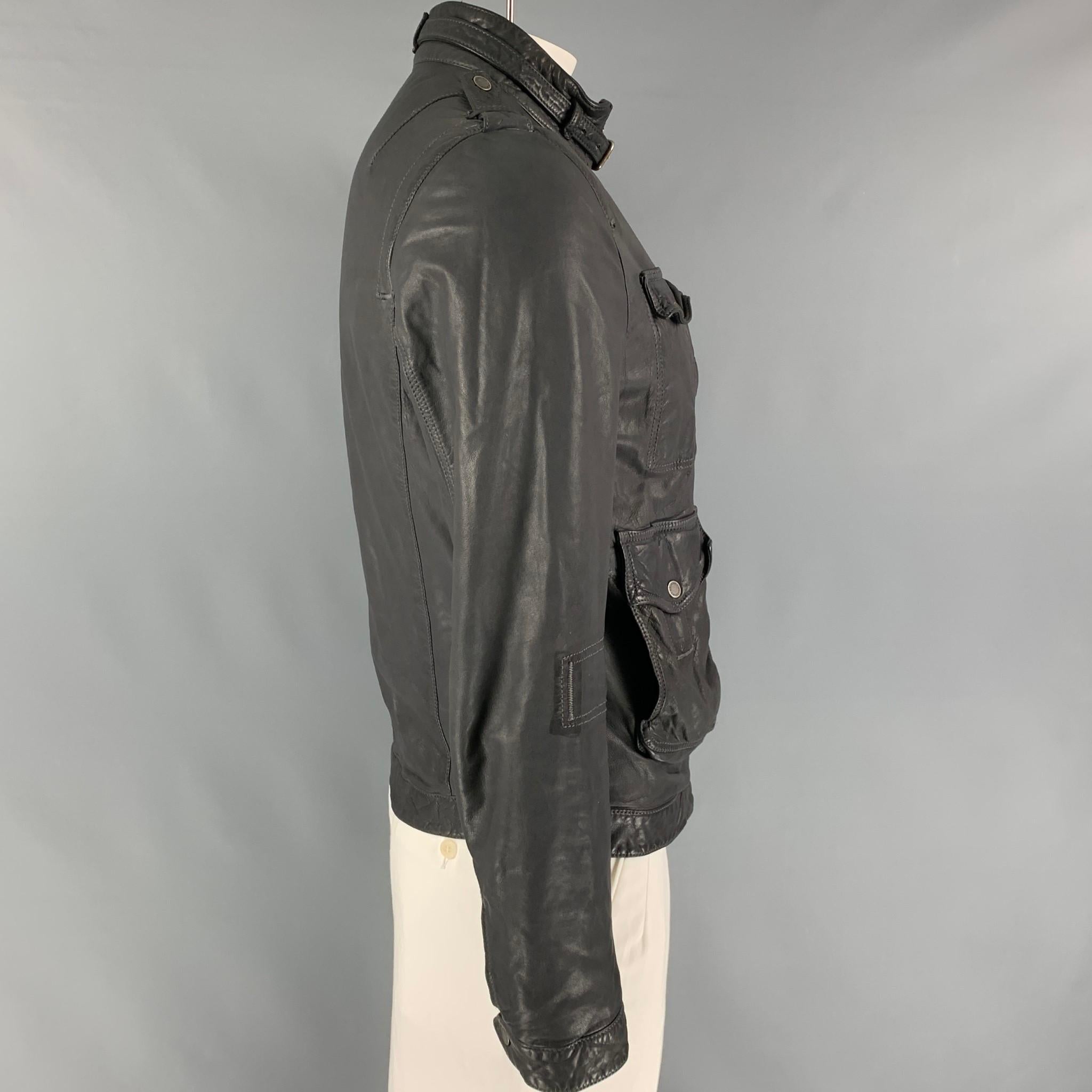 NEIL BARRETT jacket comes in a smoke gray distressed leather featuring a utility style, front pockets, epaulettes strap buckle collar detail, and a full zip up closure. Made in Italy. 

Very Good Pre-Owned Condition.
Marked: