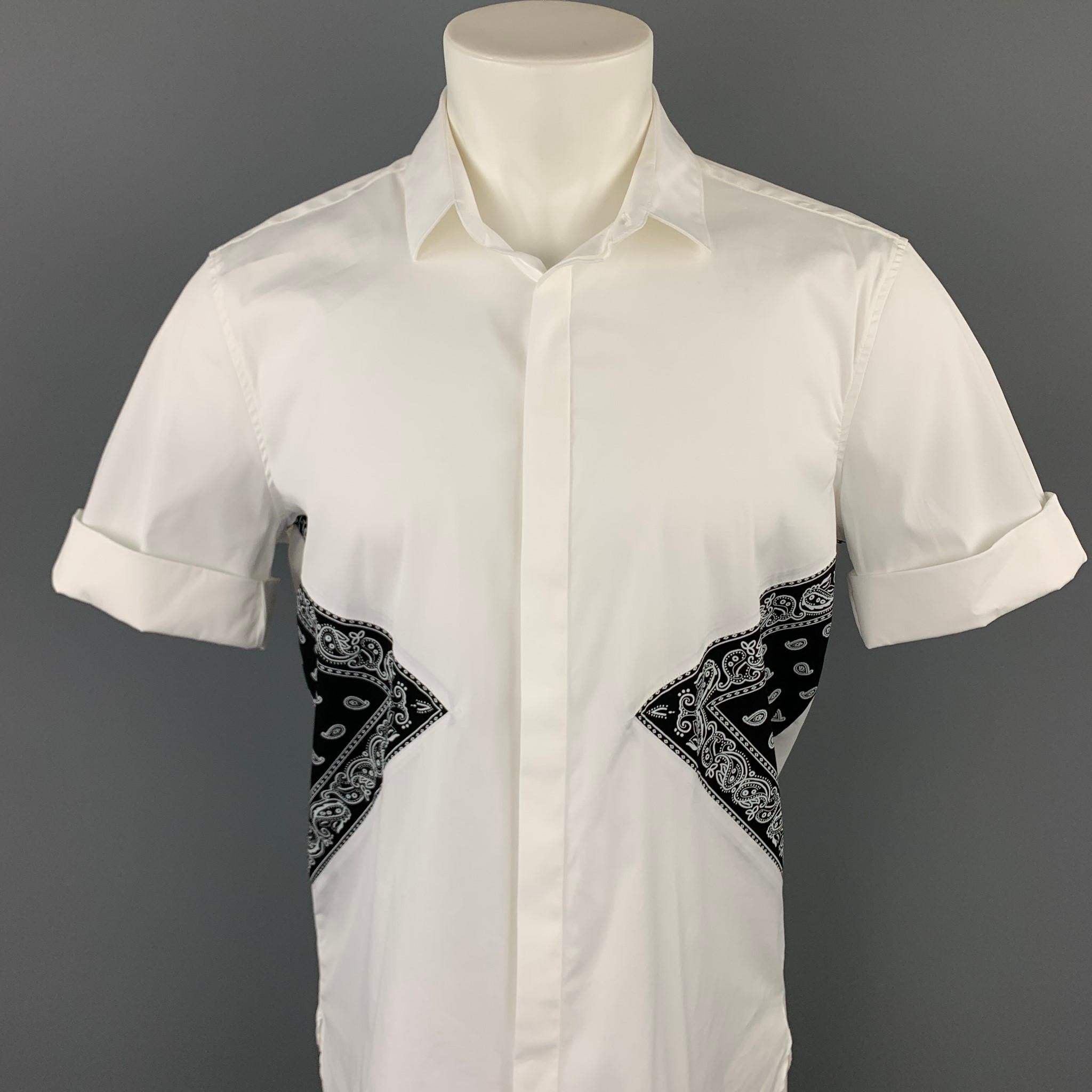 NEIL BARRETT short sleeve shirt comes in a white cotton wih a black bandana print trim featuring a button up style, loose fit, cuffed sleeves, spread collar, and a hidden button closure. Made in Italy.

Very Good Pre-Owned Condition.
Marked: