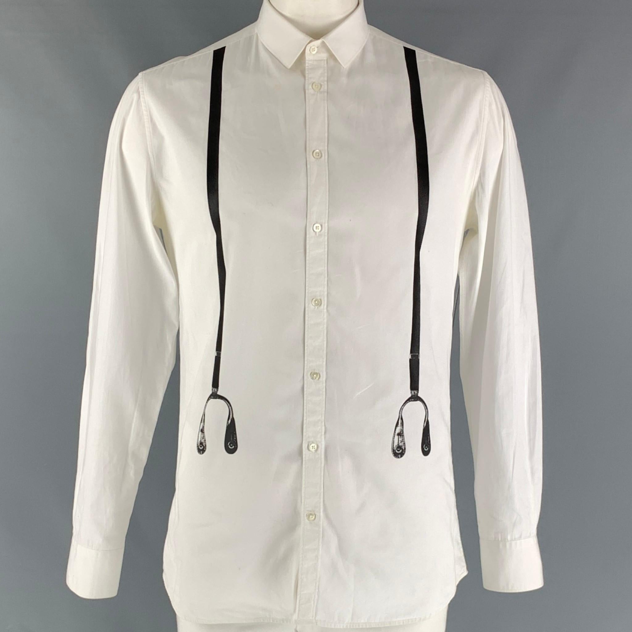 NEIL BARRETT 'slim fit' long sleeve shirt comes in a white cotton featuring a black suspenders print at front, spread collar, and buttons closure. Made in Italy.

Good Pre-Owned Condition. Moderate wear. Discolorations through out.
Marked: 42- 18