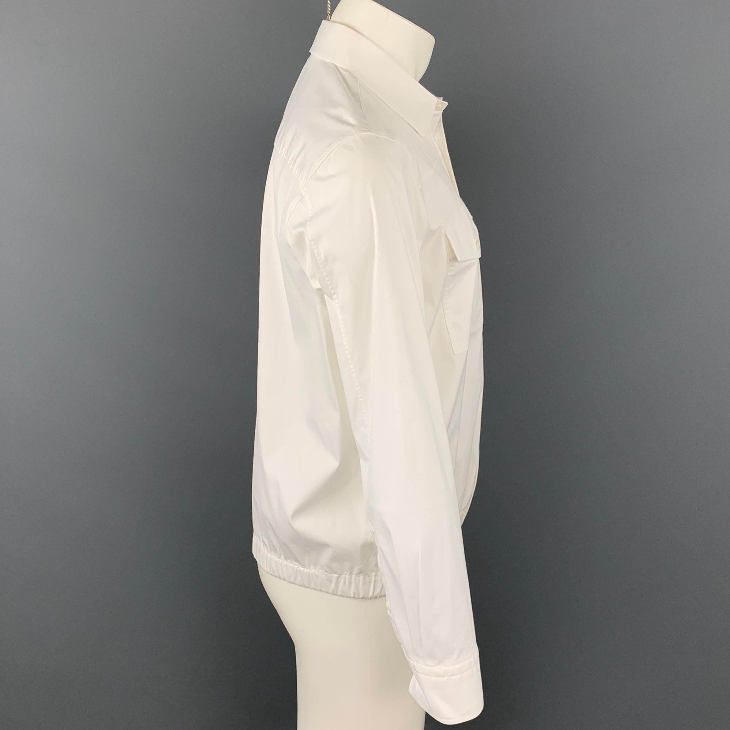 NEIL BARRET long sleeve shirt comes in a white cotton blend featuring a loose fi, elastic waistband, button up, and a spread collar.

Very Good Pre-Owned Condition.
Marked: L

Measurements:

Shoulder: 18 in.
Chest: 46 in.
Sleeve: 25.5 in.
Length: 25