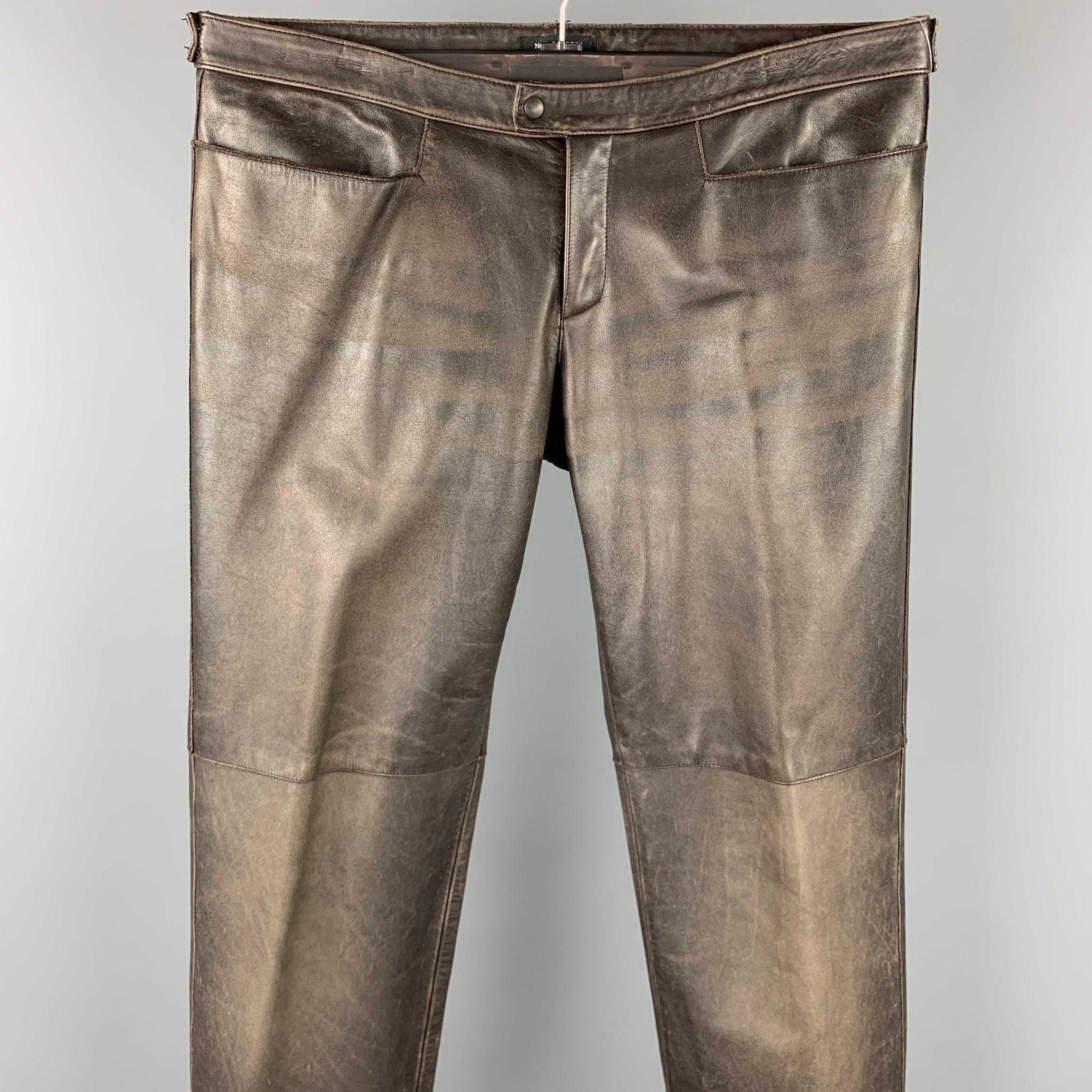 NEIL BARRETT casual pants comes in a brown distressed leather featuring a straight leg, top stitching, snap button, and a zip fly closure. Made in Italy.

Very Good Pre-Owned Condition.
Marked: M

Measurements:

Waist: 34 in. 
Rise: 6.5 in. 
Inseam: