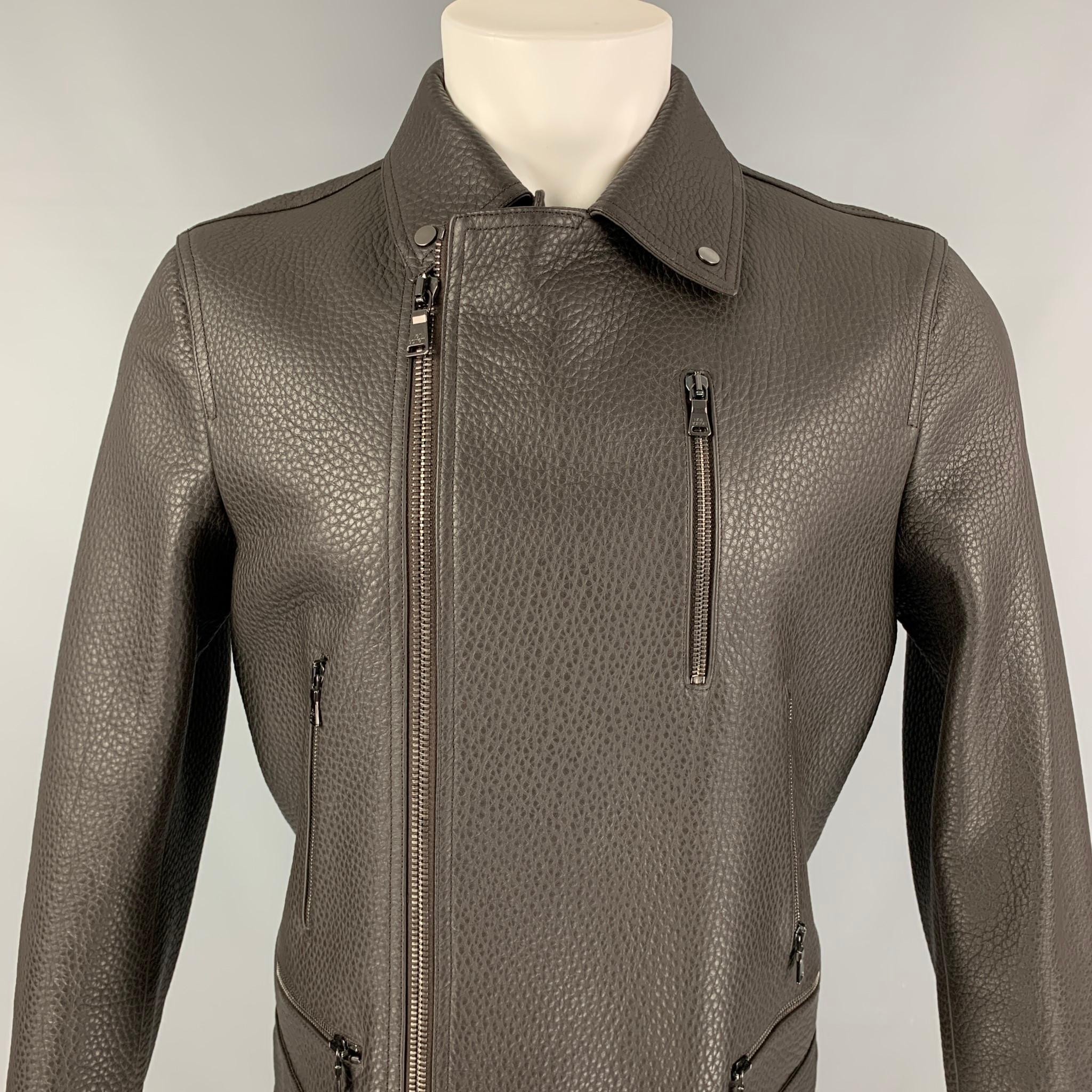 NEIL BARRETT jacket comes in a brown pebble grain leather with a full liner featuring a biker style, front zipper pockets, silver tone hardware, snap button details, and a zip up closure. Made in Italy. 

New Without Tags. 
Marked: M
Original Retail