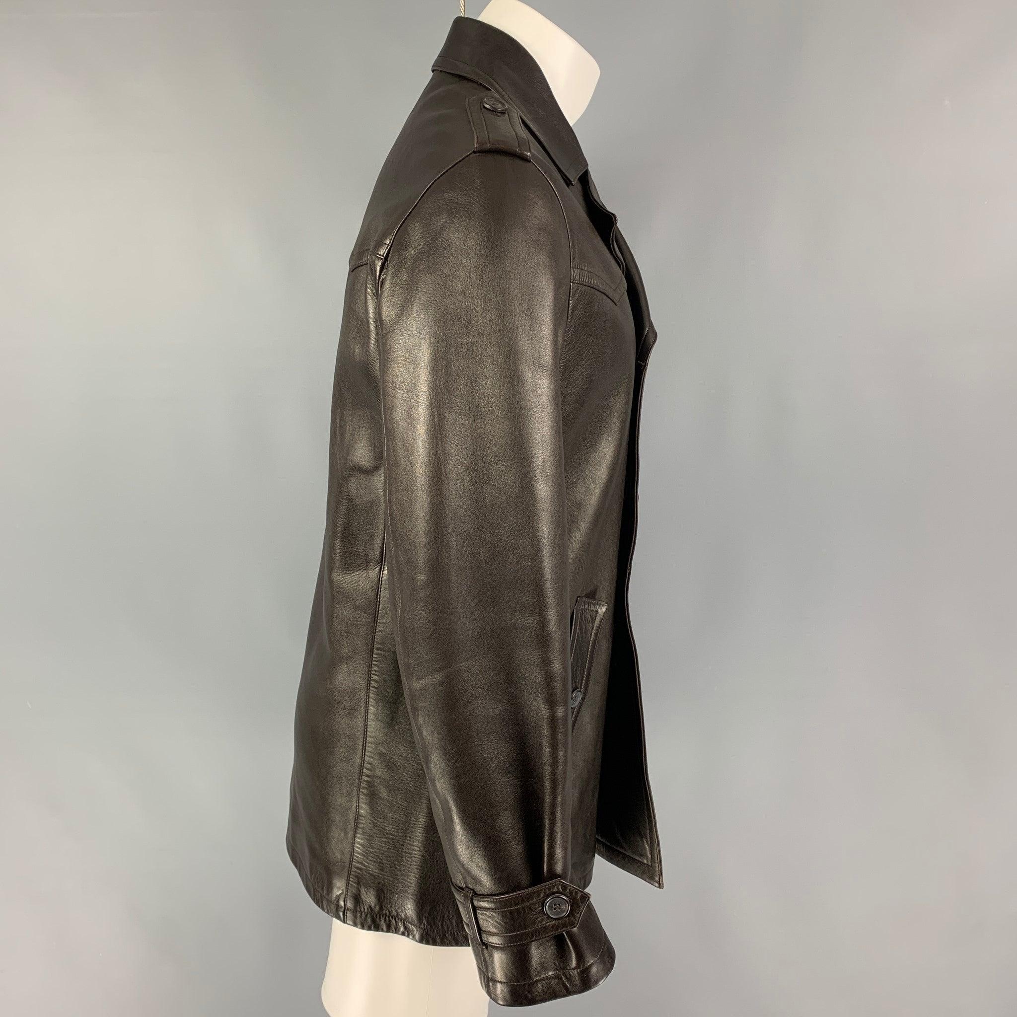 NEIL BARRETT coat comes in a dark brown leather with a full liner featuring flap pockets, epaulettes, large lapel, and a double breasted closure.
Very Good
Pre-Owned Condition. 

Marked:   M  

Measurements: 
 
Shoulder: 18 inches Chest:
40 inches