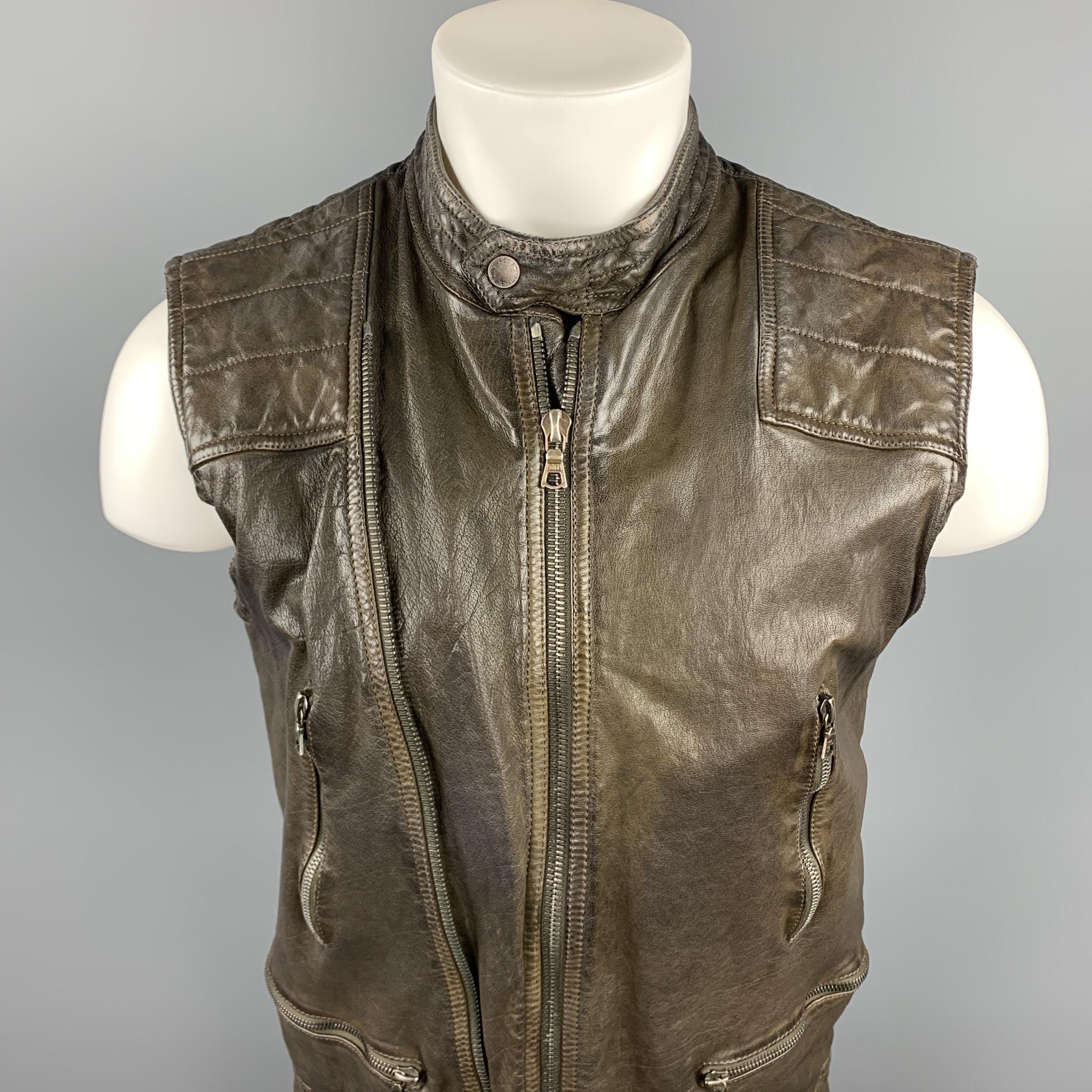 NEIL BARRETT vest comes in a brown distressed water buffalo leather featuring a slim fit, military camo print liner, quilted panel, exposed zipper detail, zipper pockets, and a zip up closure. Made in Italy.  Retail $1995

Excellent Pre-Owned