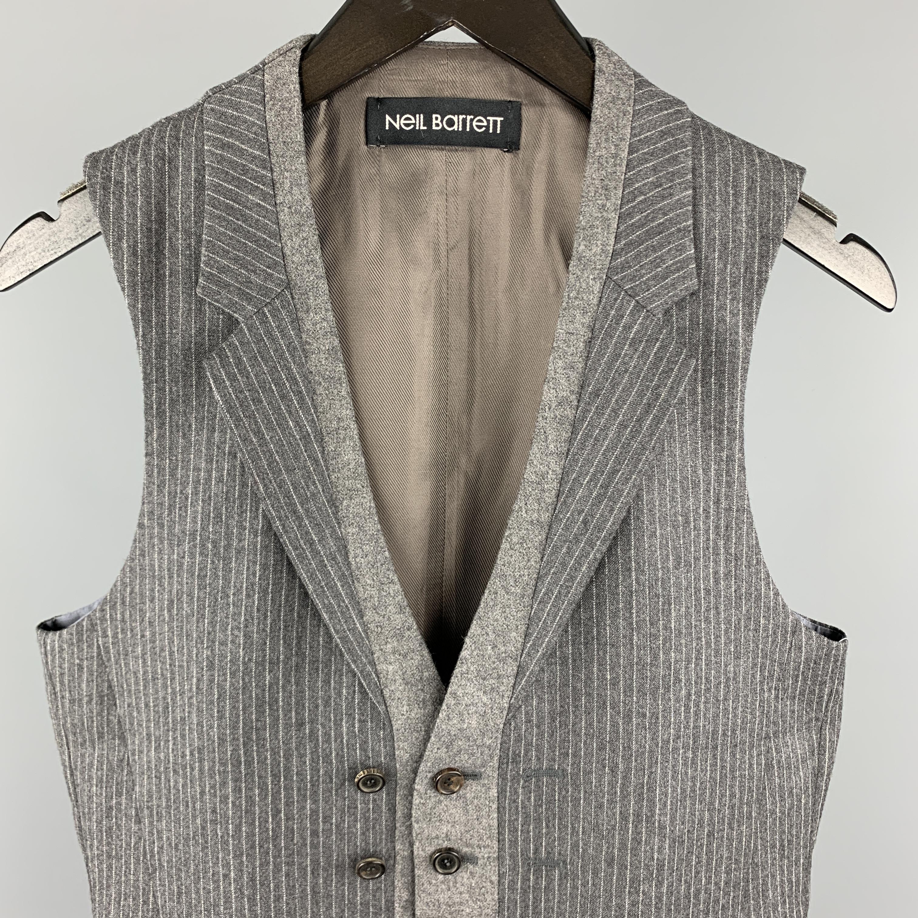 NEIL BARRET vest comes in a gray stripe wool material, with a notch lapel, a solid grey trim, a double buttoned front, and slit pockets. 

Excellent Pre-Owned Condition.
Marked: S

Measurements:

Shoulder: 13 in. 
Chest: 37 in. 
Length: 26 in.