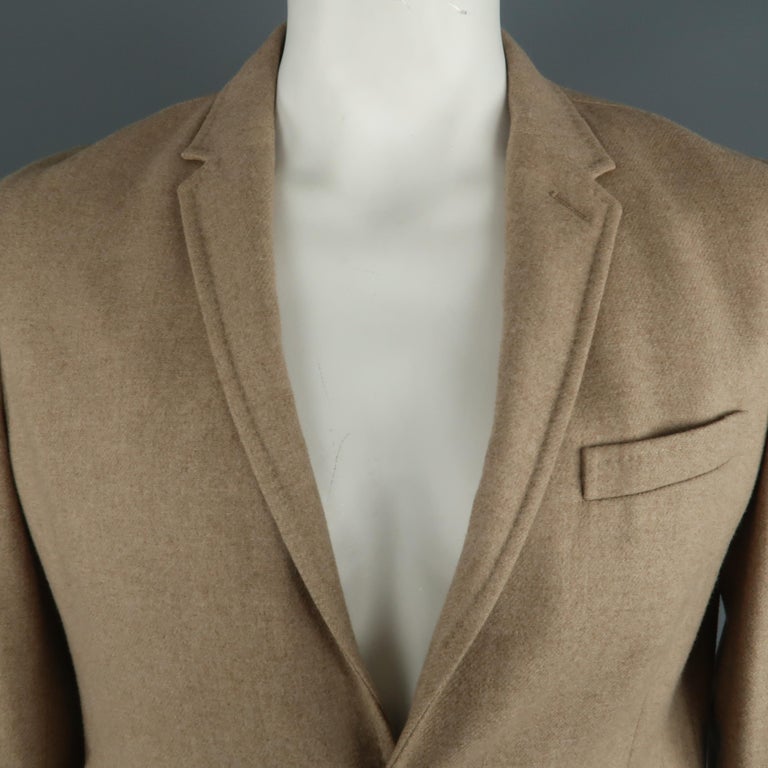 NEIL BARRETT sport coat comes in a camel wool featuring a notch lapel, two button closure, and flap pockets. Made in Italy.
 
Excellent Pre-Owned Condition.
Marked: XL
 
Measurements:
 
Shoulder: 19 in.
Chest: 42 in.
Sleeve: 26 in.
Length: 27.5 in.