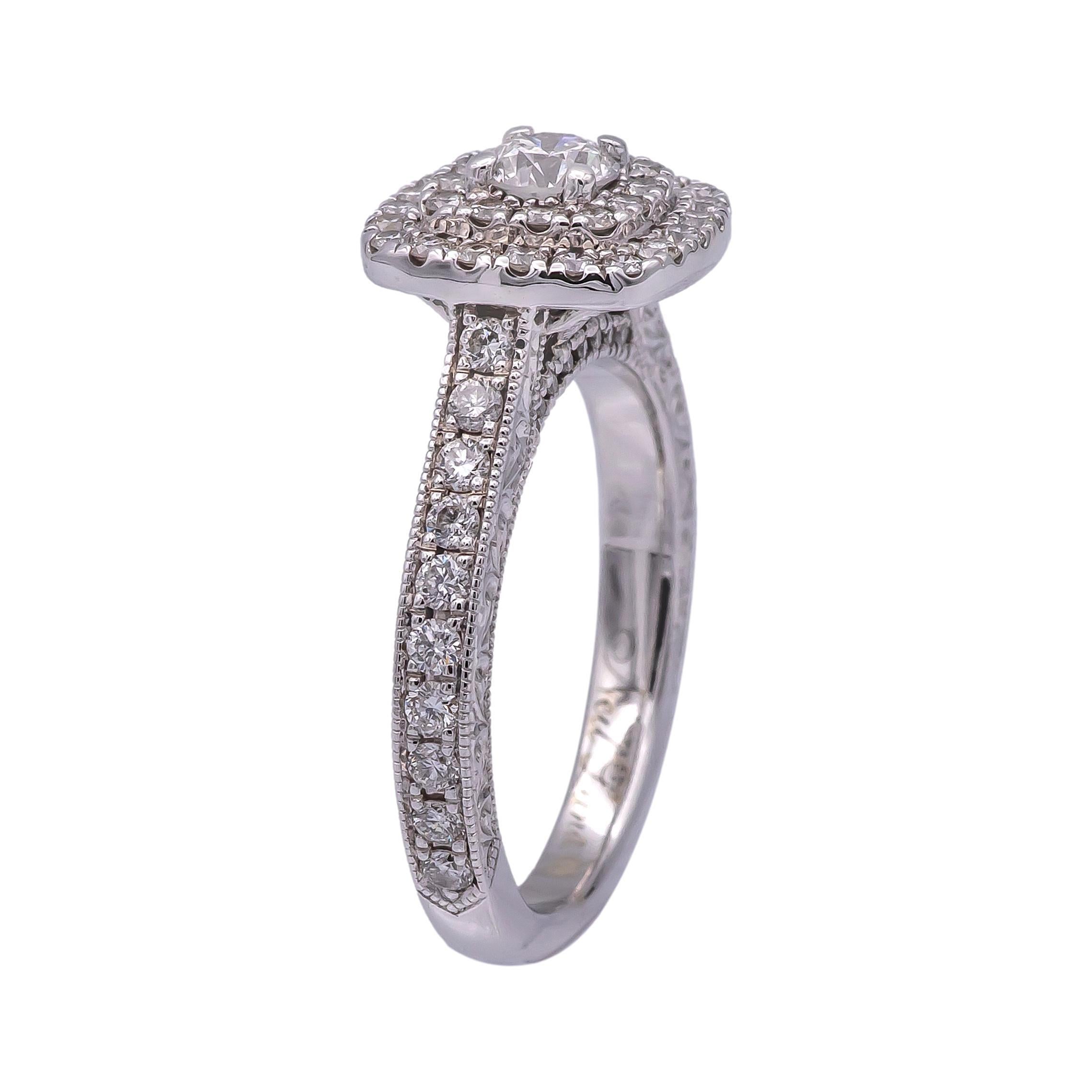 Diamond Engagement ring designed by Neil Lane finely crafted in 14 karat white gold featuring a round brilliant cut diamond center weighing 0.25 carats adorned by 2 rows of bead set diamonds creating a cluster of diamonds that showcase brilliance