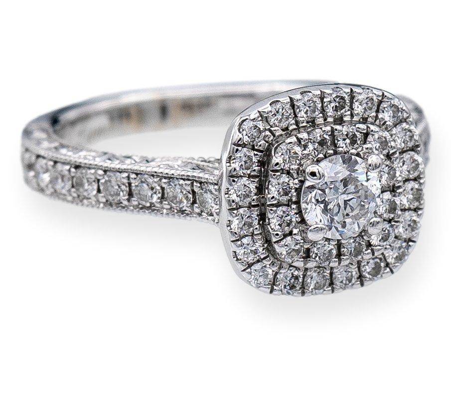 Diamond Engagement ring designed by Neil Lane finely crafted in 14 karat white gold featuring a round brilliant cut diamond center weighing 0.25 carats adorned by 2 rows of bead set diamonds creating a cluster of diamonds that showcase brilliance