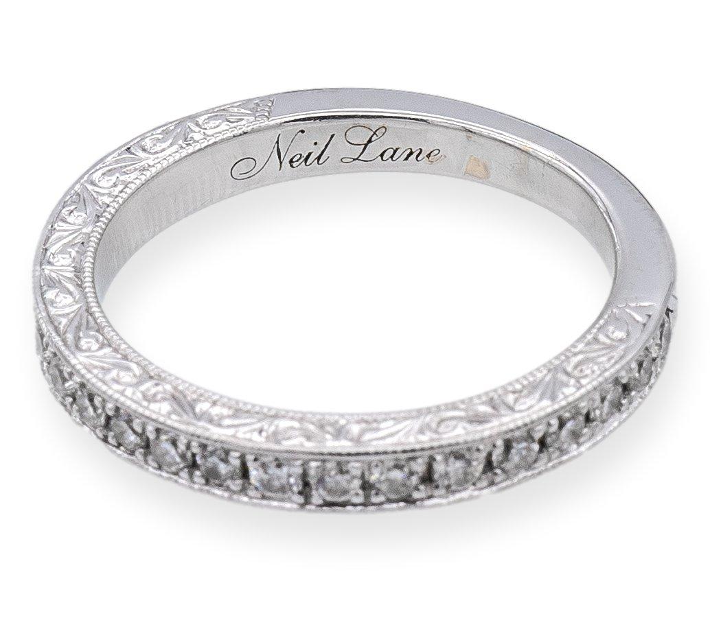 Diamond Wedding band designed by Neil Lane bridal collection finely crafted in 14 karat white gold featuring 23 round brilliant cut diamonds weighing a total of 0.35 carats approximately I color , I1 clarity in a mill-grain channel setting going