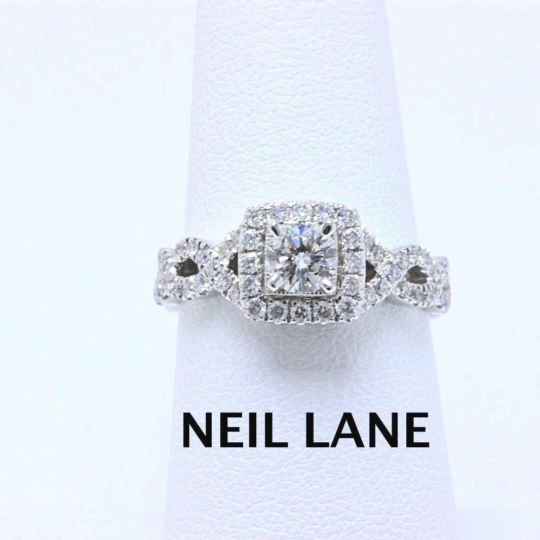 Neil Lane Bridal
Style: Halo & Twisted Band Engagement Ring
SKU Number:  #19996111
Metal: 14KT White Gold
Size:  6.5 - ( sizable)
Total Carat Weight: 1.00 TCW
Center Diamond Shape: Round Diamond 0.33 CTS
Accent Diamonds: Round Diamonds 56 Stones