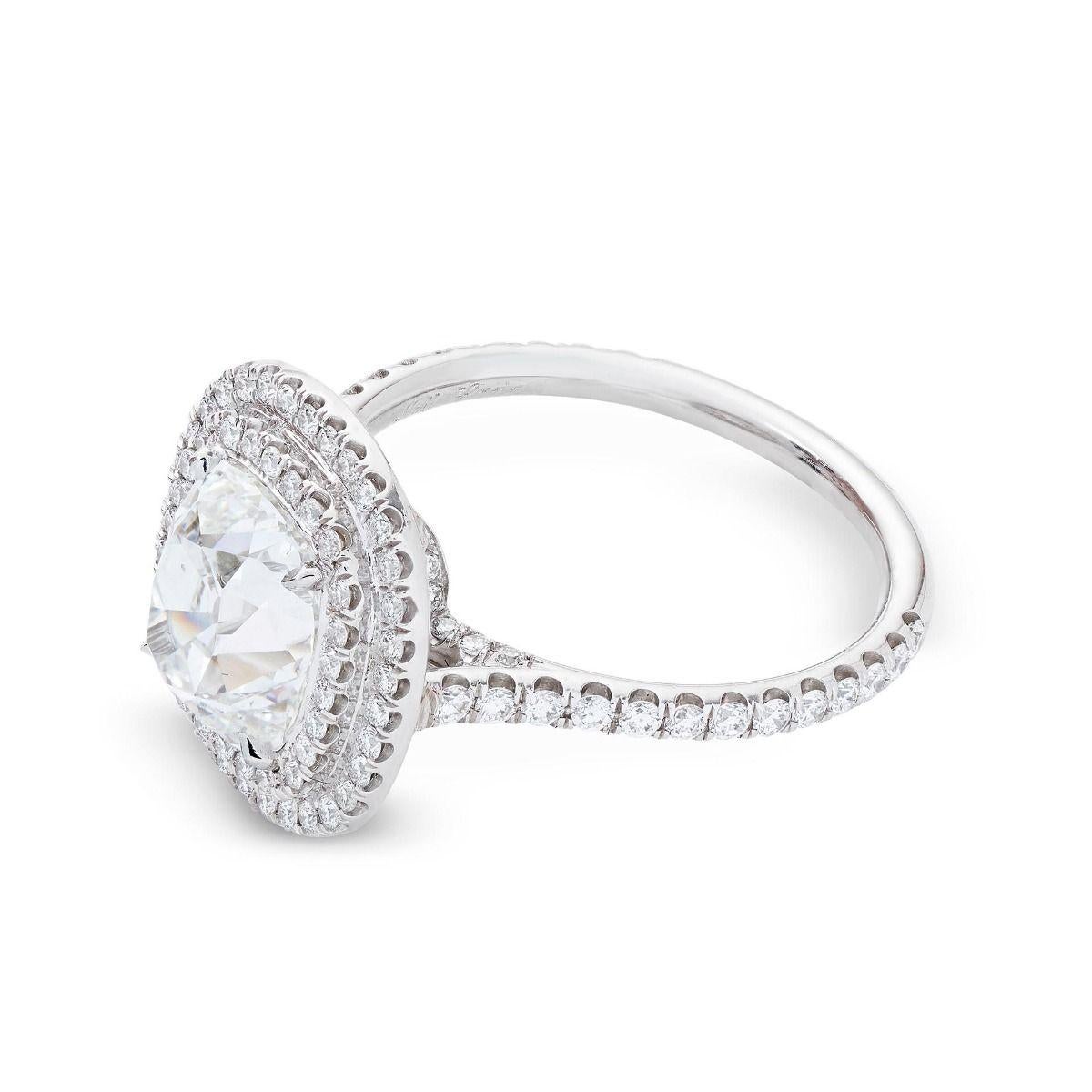 Set in platinum, this timeless handmade ring features a lavish, vintage-style cushion-cut diamond with high crown angles, weighing 2.48 cts. An accenting 102 diamonds, weighing 0.65 ct, follow a double halo and channel the diamond-studded