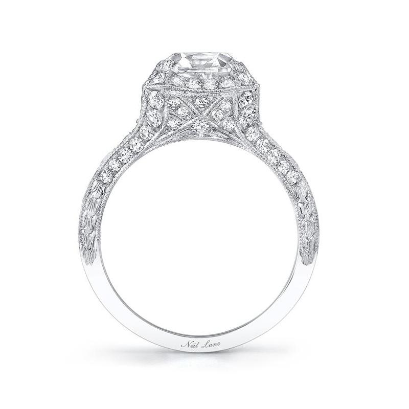 A scintillating presentation comprising a vintage cushion-shaped diamond weighing 2.07 cts with G color & VS1 clarity, set amongst tapering and octagonal linear borders in a finely millegrained platinum ring decorated throughout by seventy-eight