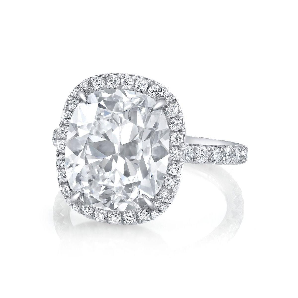 This voluptuous cushion-cut diamond of fine white color weighs 6.43 cts., the stone's turn of the century charisma is distinguished by high crowning angles, an accenting 88 round-cut diamonds, weighing 0.84 ct., form a halo and contour the band,