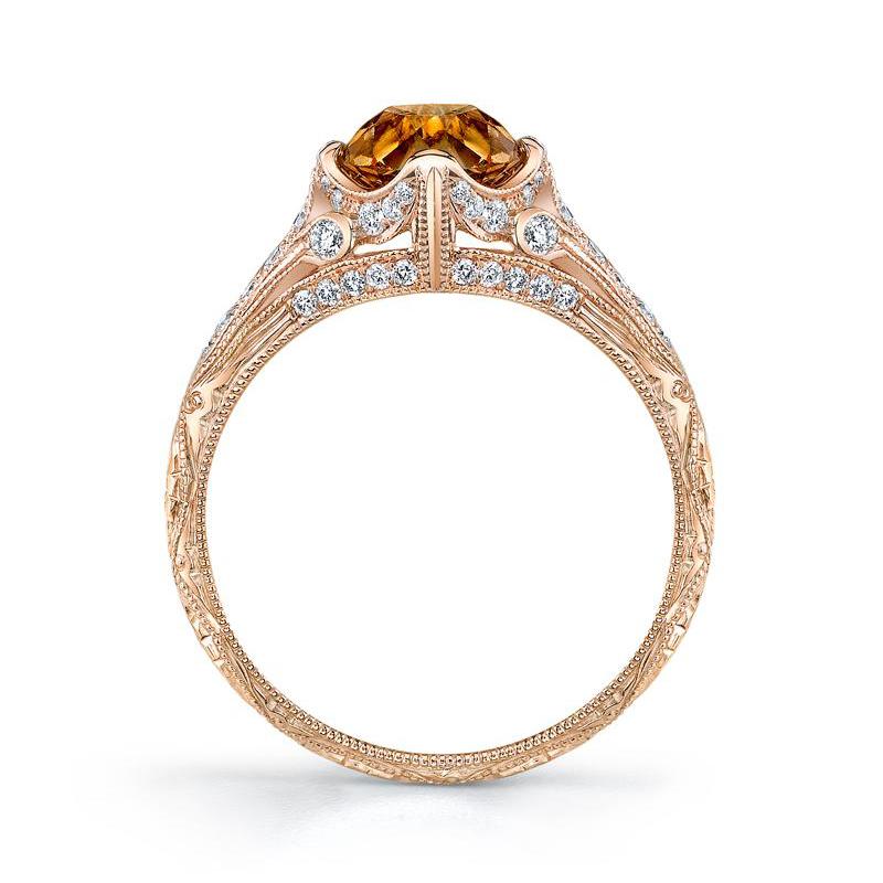 Centering upon an old mine brilliant-cut diamond weighing 1.47 cts., embracing vibrant earth tones of yellowish-brown, paired with an artful 18k rose gold finely millegrained and hand engraved ring accented throughout by thirty-six round-cut