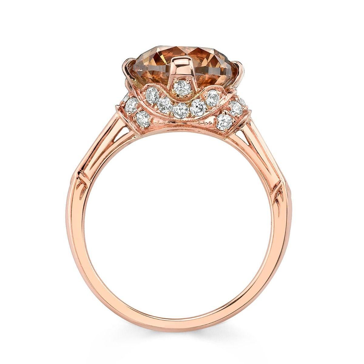 This warm combination of colors set in 18K rose gold embracing  an impressive sienna-colored diamond weighing 4.00cts. that is classified Natural Fancy Dark Yellowish Brown. An accenting 30 diamonds sharing 0.54 cts. include a draping series that
