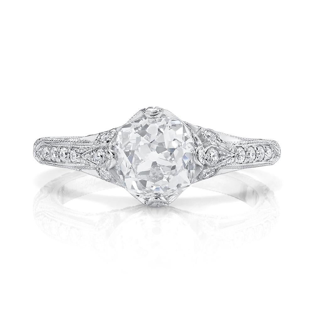 A classic ring with a touch of elegant flair, set with an Old European-cut diamond weighing 1.45 cts., H Color & SI1 Clarity, accented by fifty-four full-cut diamonds weighing 0.35 ct., set in finely millegrained platinum,

Designed & signed by Neil