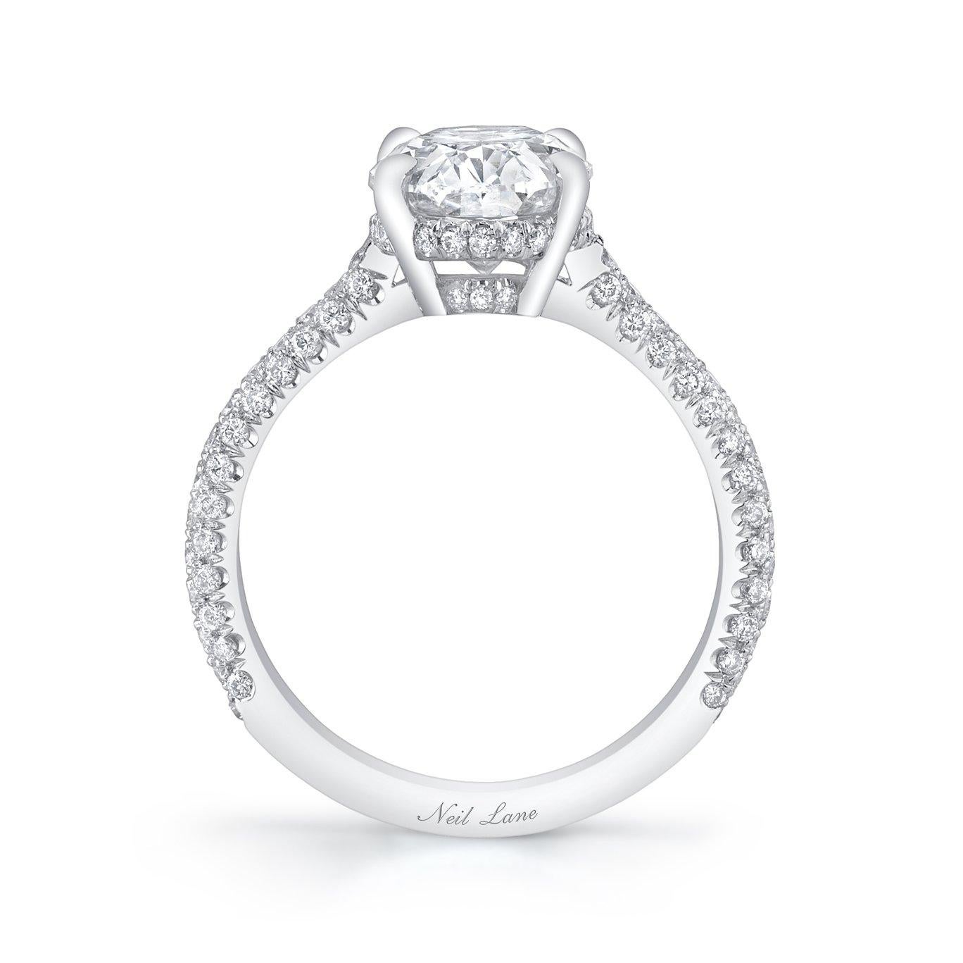 The elegant contour of this oval-shaped diamond is a perfect companion to this time honored solitaire ring, handmade in platinum, completed by one hundred twelve full-cut diamonds forming the three sided platinum shank, weighing a total of 0.48 ct.,