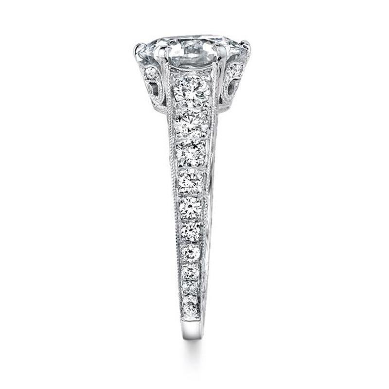 This lustrous Neil Lane designed ring features a central round brilliant-cut diamond weighing 2.19 cts., H Color & VS2 Clarity, the handmade platinum mounting cascading into three sections of one hundred and two full-cut diamonds weighing 1.07