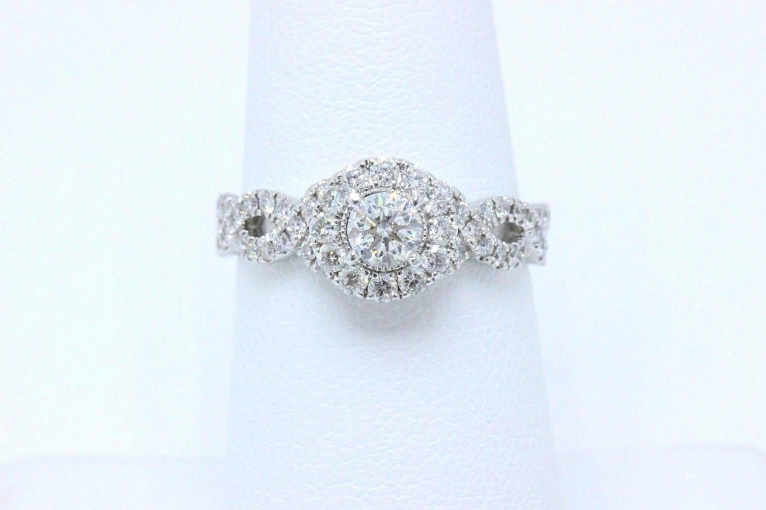 NEIL LANE BRIDAL COLLECTION
Style:  Halo with Diamond Pave Twisted Band 
Item Number:  20025416
Metal:  14K White Gold
Size:  6.75 - Sizable
Total Carat Weight:  1.00 TCW
Center Diamond Shape:  0.30 CTS
Diamond Color & Clarity:  I / I1
Accent