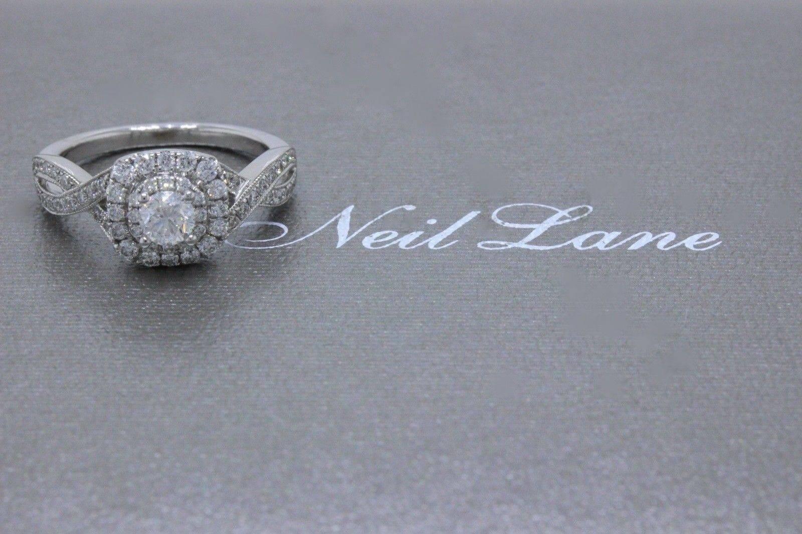 NEIL LANE BRIDAL
Style:  Double Halo Twist Band Engagement Ring
Sku Number:  #940258611
Metal:  14KT White Gold
Size:  5.5 - Sizable
Total Carat Weight:  3/4 TCW
Diamond Shape:  Round Diamond 0.33 CTS
Diamond Color & Clarity:  I / I1
Accent