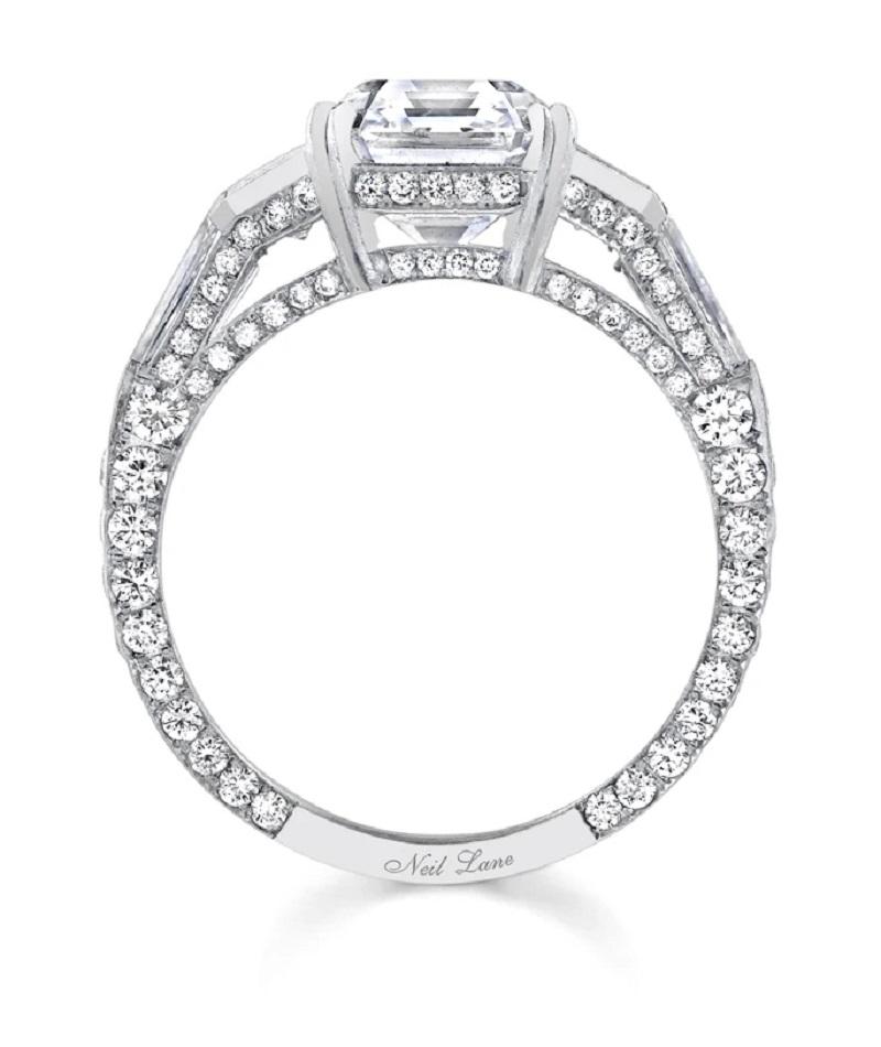 Architectural in design, this timeless handmade platinum ring centers upon an vintage emerald-cut diamond weighing 3.28 cts., G Color & VS1 Clarity, embellished throughout by one hundred twenty-eight round-cut and fancy-cut diamonds weighing 2.14