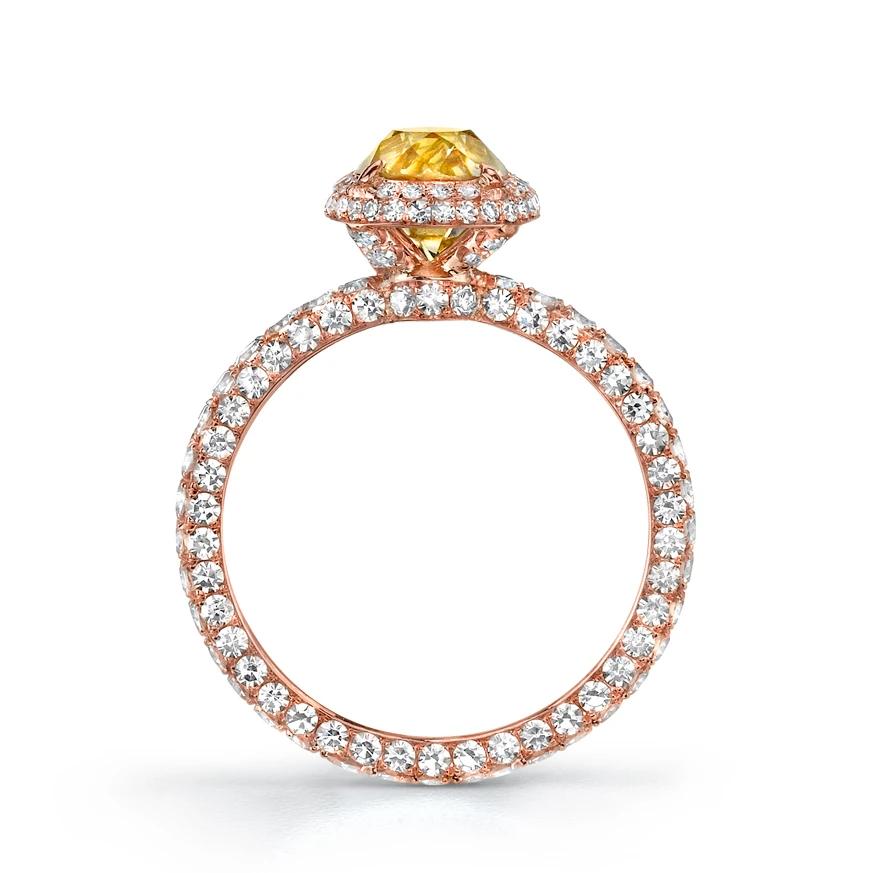 The handmade 18k rose gold ring, resplendent with one hundred seventy-five round-cut diamonds weighing 1.42 cts., centers upon an old mine brilliant-cut Natural Fancy Brownish Yellow diamond weighing 1.39 cts.

Designed and signed by Neil Lane