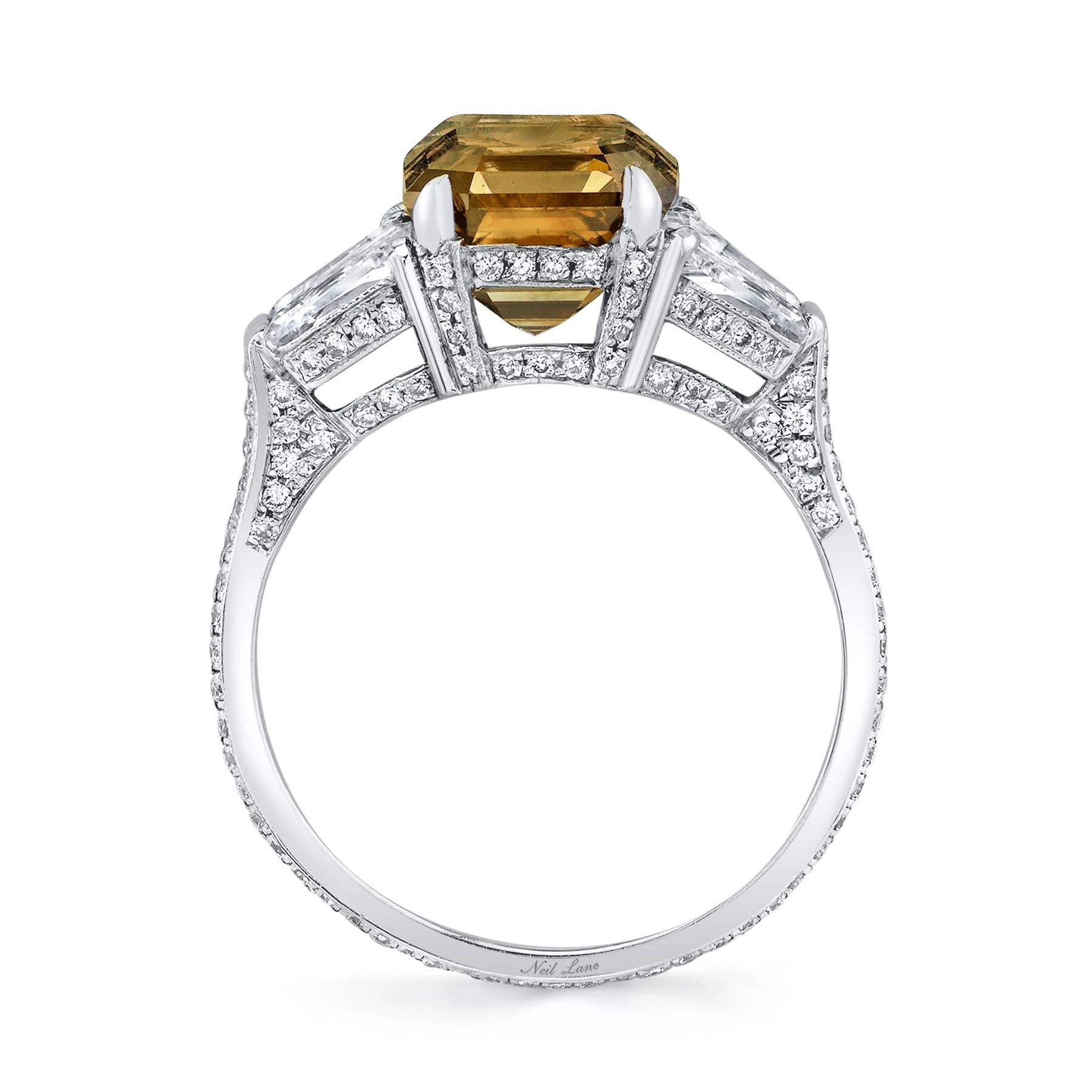 A compelling 3.02 CT, Natural Fancy Dark Orange-Brown square emerald-cut diamond creates an important presence in this platinum ring, paired with two trapezoid-cut diamonds weighing 1.00 ct., further supporting these three stone are one hundred