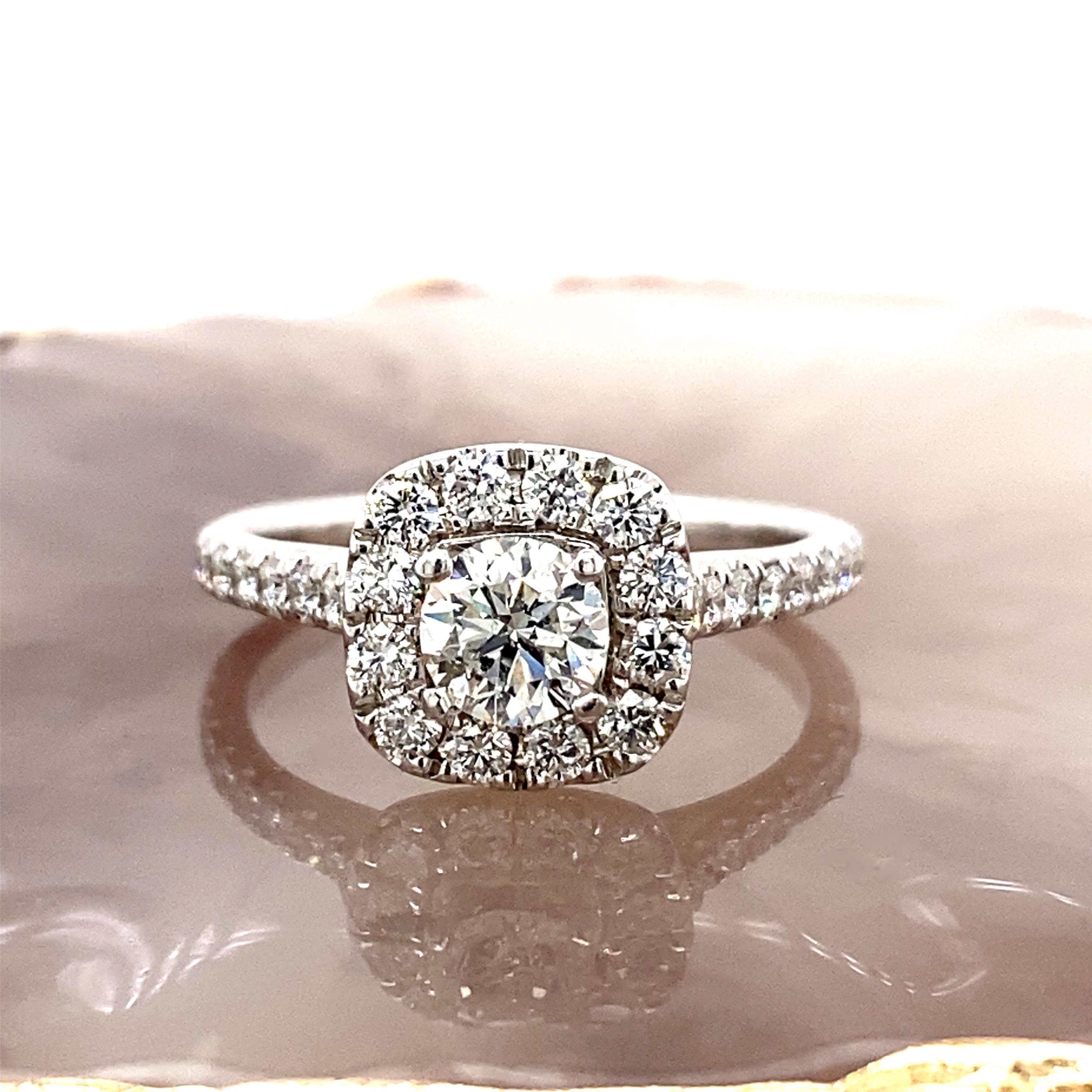 Neil Lane Diamond Halo Engagement Ring
Style:  Halo 
Metal:  14kt White Gold
Size:  9 - sizable
TCW:  1.27 tcw
Main Diamond:  Round Brilliant Diamond 0.73 cts
Color & Clarity:  I, I1
Accent Diamonds:   52 Round Brilliant Cut Diamonds I, I1
Hallmark: