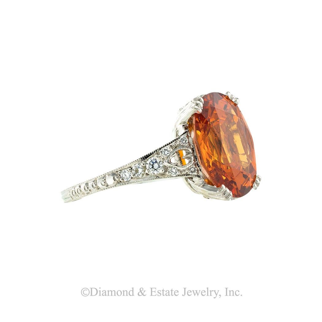 Neil Lane spessartite garnet diamond and platinum ring. *

SPECIFICATIONS:

CENTER GEM:  one oval-shaped, faceted, spessartite garnet weighing approximately 7.65 carats.

DIAMONDS:  twenty round brilliant-cut diamonds totaling approximately 0.20