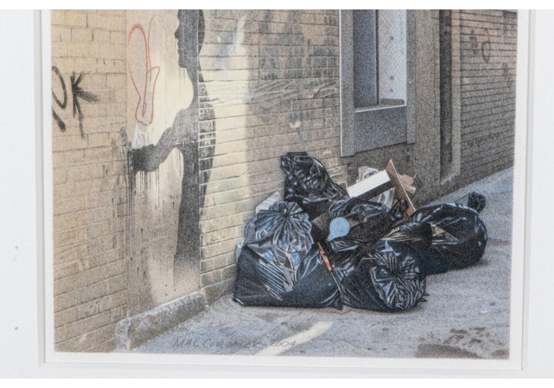 Signed and dated 2004 lower center, and signed on verso. NY gallery labels on verso.
An alley way with black garbage bags and the silhouette shadow of a figure on the brick wall with graffiti. The artist, a realist painter, is known for renderings