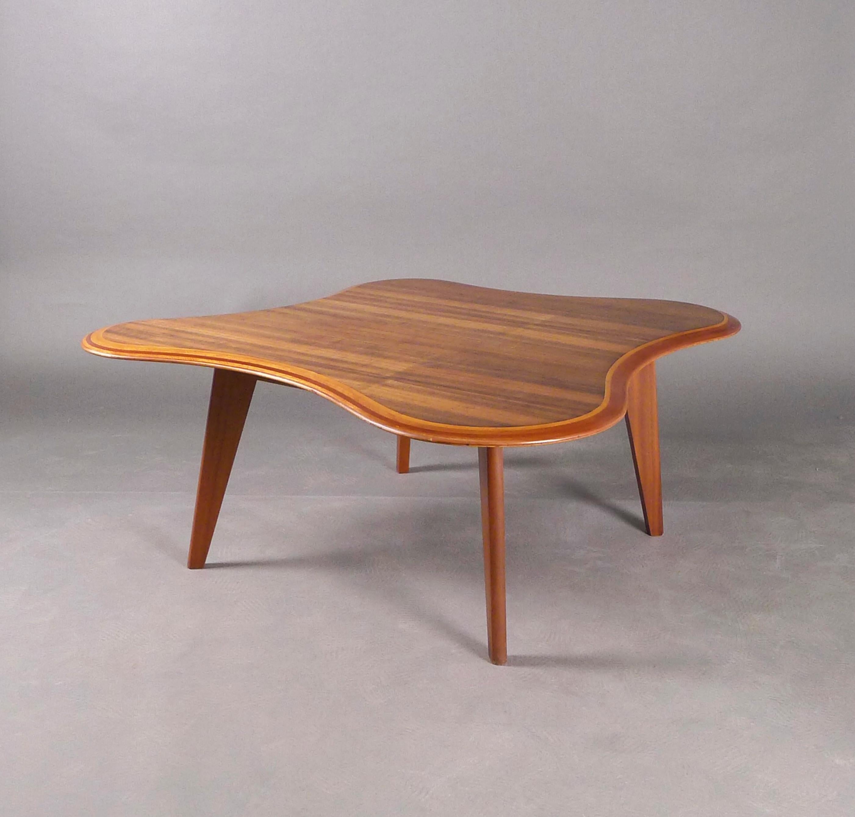 Stunning mid-century Cloud Table, designed by Neil Morris in 1947 and made by H. Morris & Co, Glasgow.

The rosewood and betula laminates have been chamfered to create contrasting border stripes around the irregular shaped edge.  The top has a