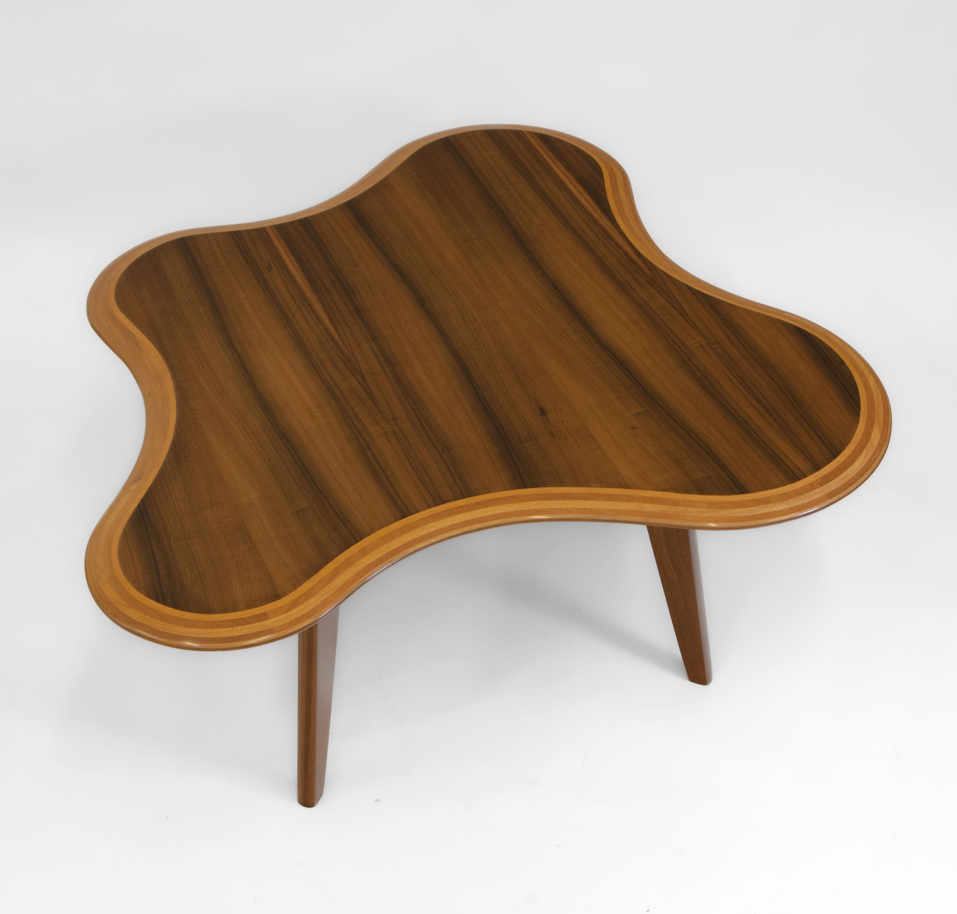 Superb sinuous cloud coffee table designed by British designer Neil Morris in 1947 for Morris of Glasgow, circa late 1940s.

The top is veneered in striking Queensland walnut, the chamfered top edge exposing the contrasting ply. Standing on